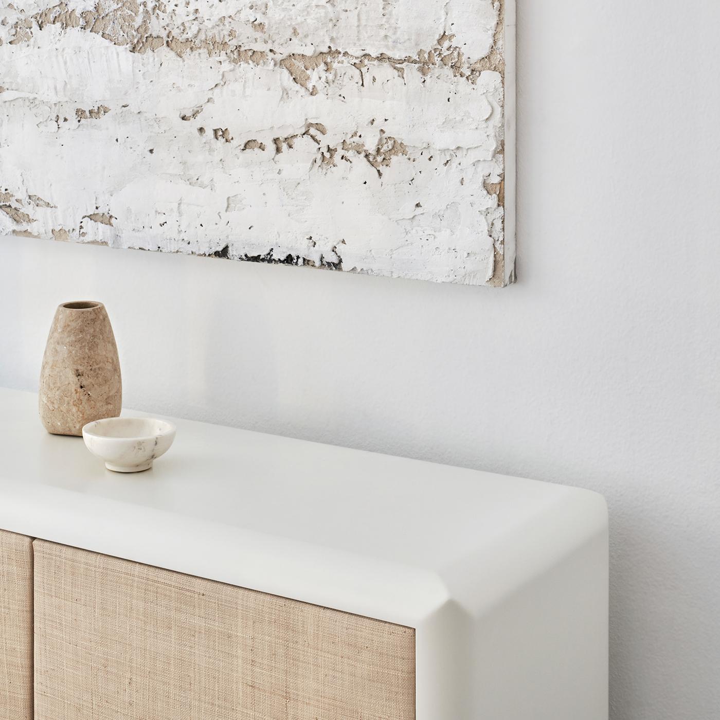 Clean refinement and essential minimalism define this gorgeous sideboard, boasting a simple and compact shape comprised of four doors. Crafted of white lacquered wood, it will make a versatile and timeless addition to modern decor.