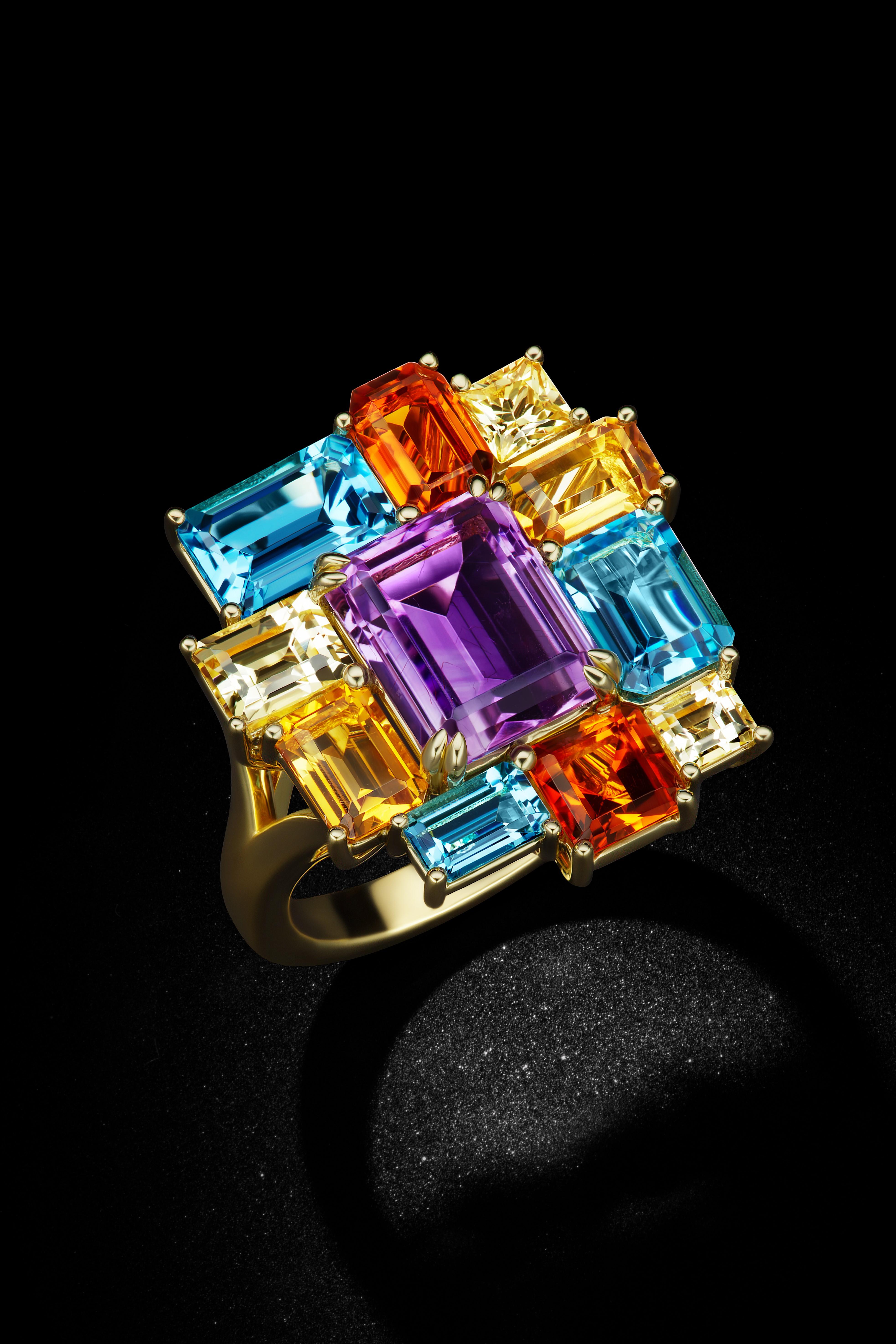This 18K Yellow Gold Ring with its staggered shapes is reminiscent of the Colorama years. The array of colors and cuts are a mosaic of an  Amethyst, Blue topaz, Yellow Citrine , Golden Citrine and Yellow Sapphires at 9 carats total. 

