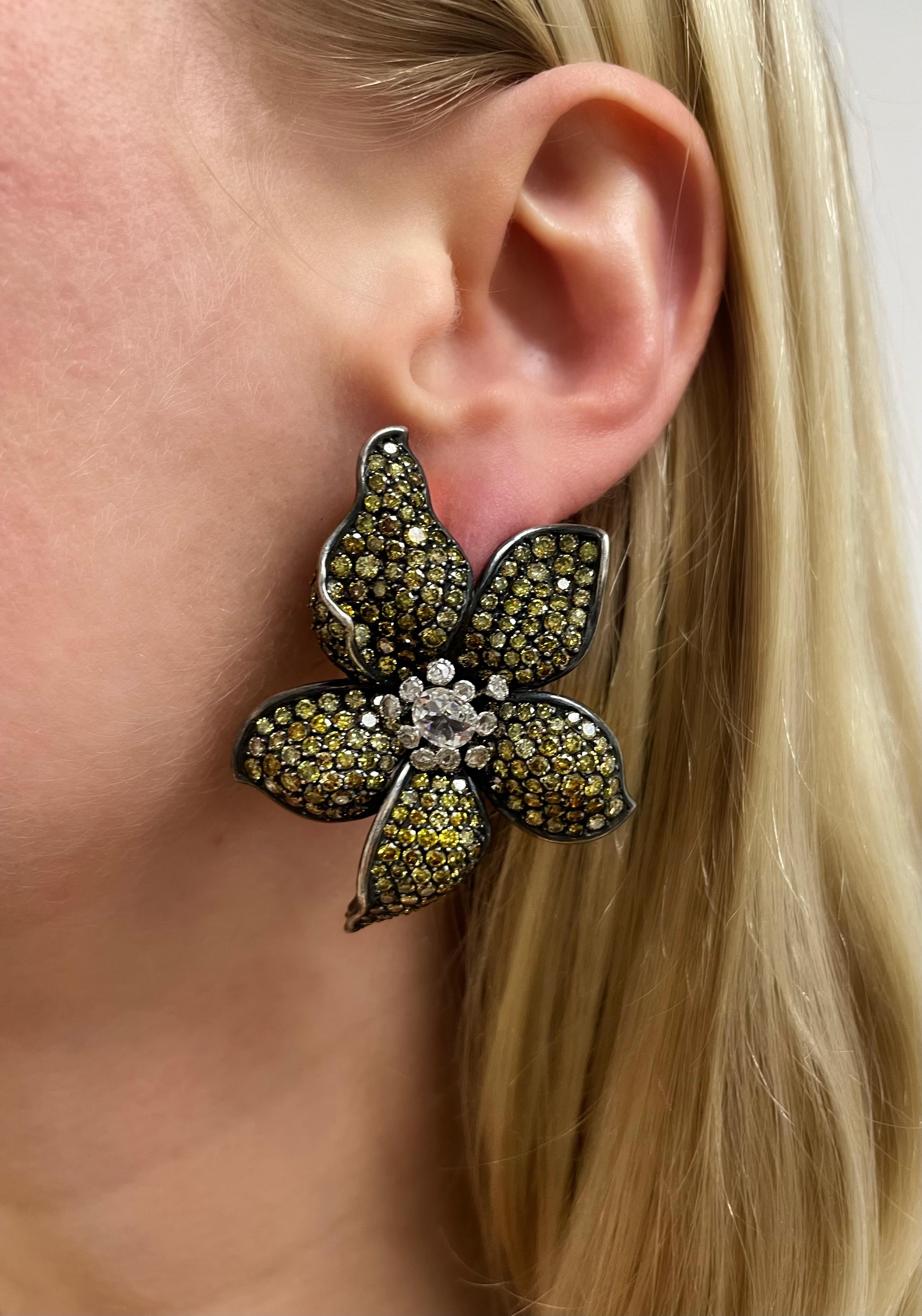 These absolutely gorgeous flower earrings boast two antique cut diamonds weighing approximately 1.00 carat total surrounded by 20 rose cut diamonds and numerous round brilliant cut yellow diamonds (origin of color not tested) weighing approximately