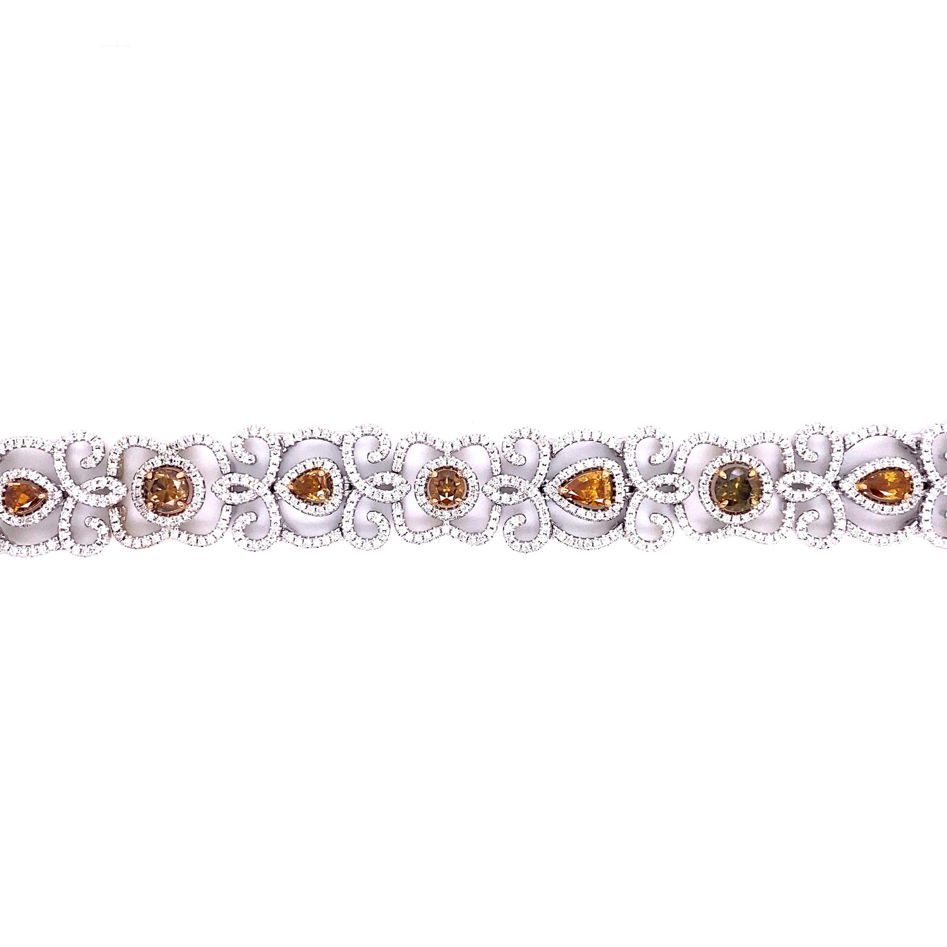 Colored Diamond and White Diamond Bracelet 

This unique bracelet features 4.11 carats of colored diamonds from champagne to deep orange hues all set with prongs in 18 karat yellow gold. Each colored diamond is surrounded by a whimsical pattern of