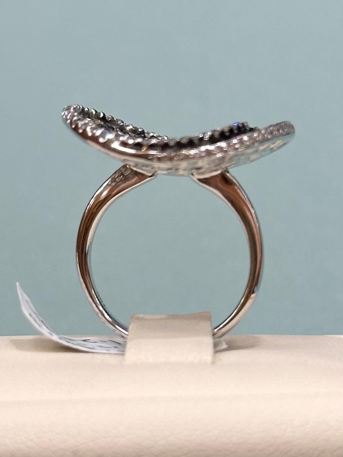 Colored Diamond and White Diamond Spiral Ring set in 18k White Gold with 0.70 cts of colored diamonds and 0.22 cts of  white diamonds. 

Total weight 11.29 grams.