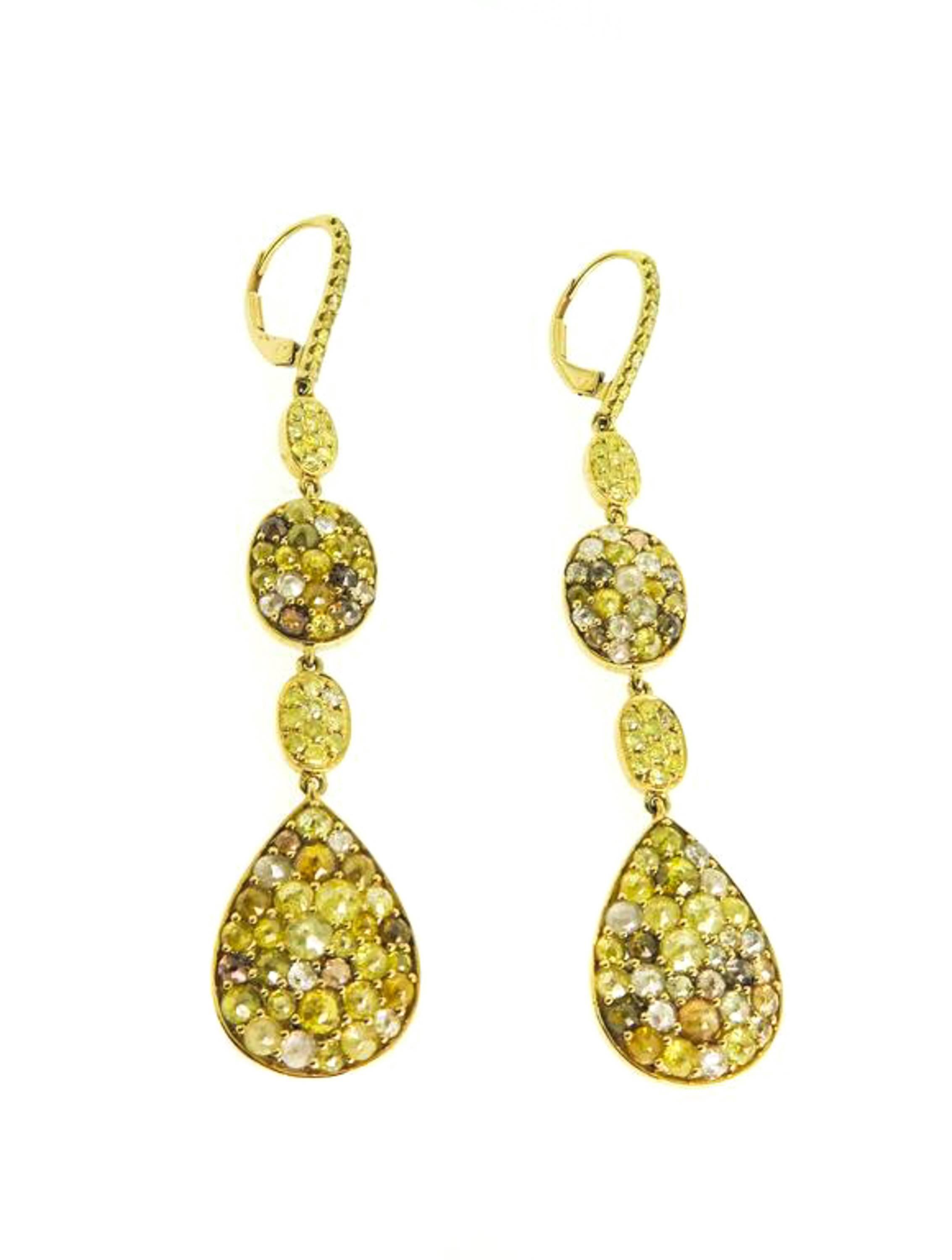 These artistically designed and  fascinating earrings embellish the enchanting radiance of the exceptionally shaped rose cut diamond with white, champagne and fancy yellow colored diamonds weighing in approximately 8.82 carats for a glamorous
