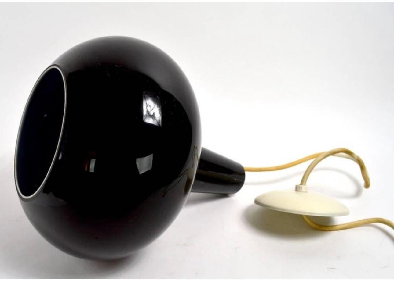 Black cased glass pendant light in teardrop form. This shade creates a textured effect when lit, as shown. Retains original early label. 
 Fixture comes with original canopy and cord .. Classic Modernist Design. 