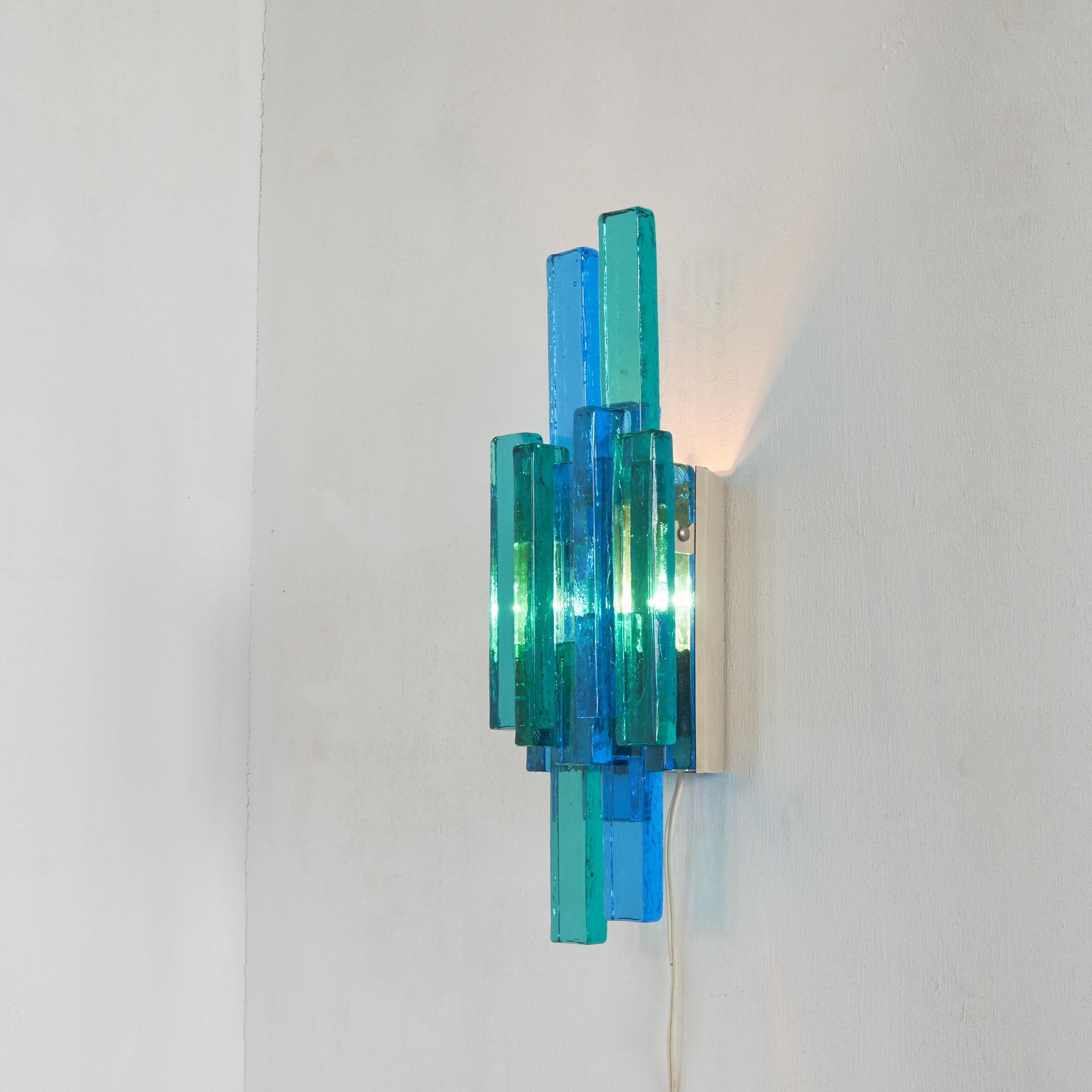 Sconce in vibrant colors by famous lighting designer Svend Aage Holm-Sørensen (1913-2004) for his company Holm Sørensen & Co.

Svend Aage Holm-Sørensen is known for a wide range of mostly colorful lighting designs, but was also a metalworker and