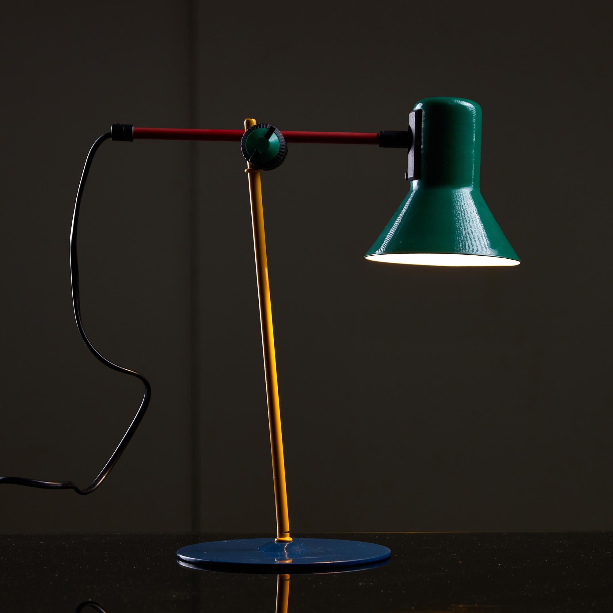 Colored metal table lamp from the 1990s, with a round blue base, green hood, and red-yellow adjustable stem. Inspired by the design of Ettore Sottsass, the funky Serie Z1-90 was produced by Veneta Lumi. Available in a fully functional condition,
