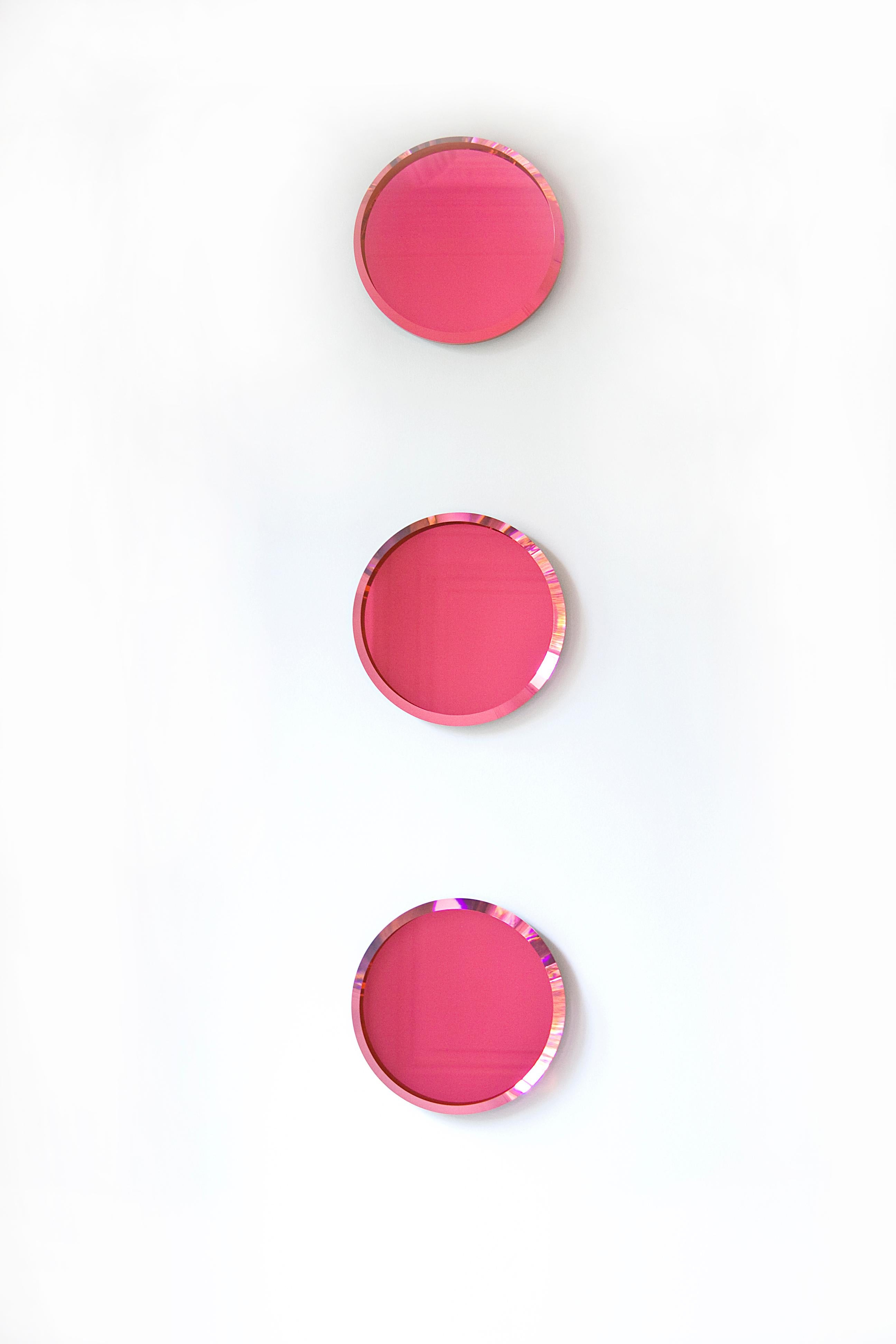 This wall mounted circular colored glass and mirror decoration is an eye-catching focal point playing with color and reflection!
Available in pink or blue.