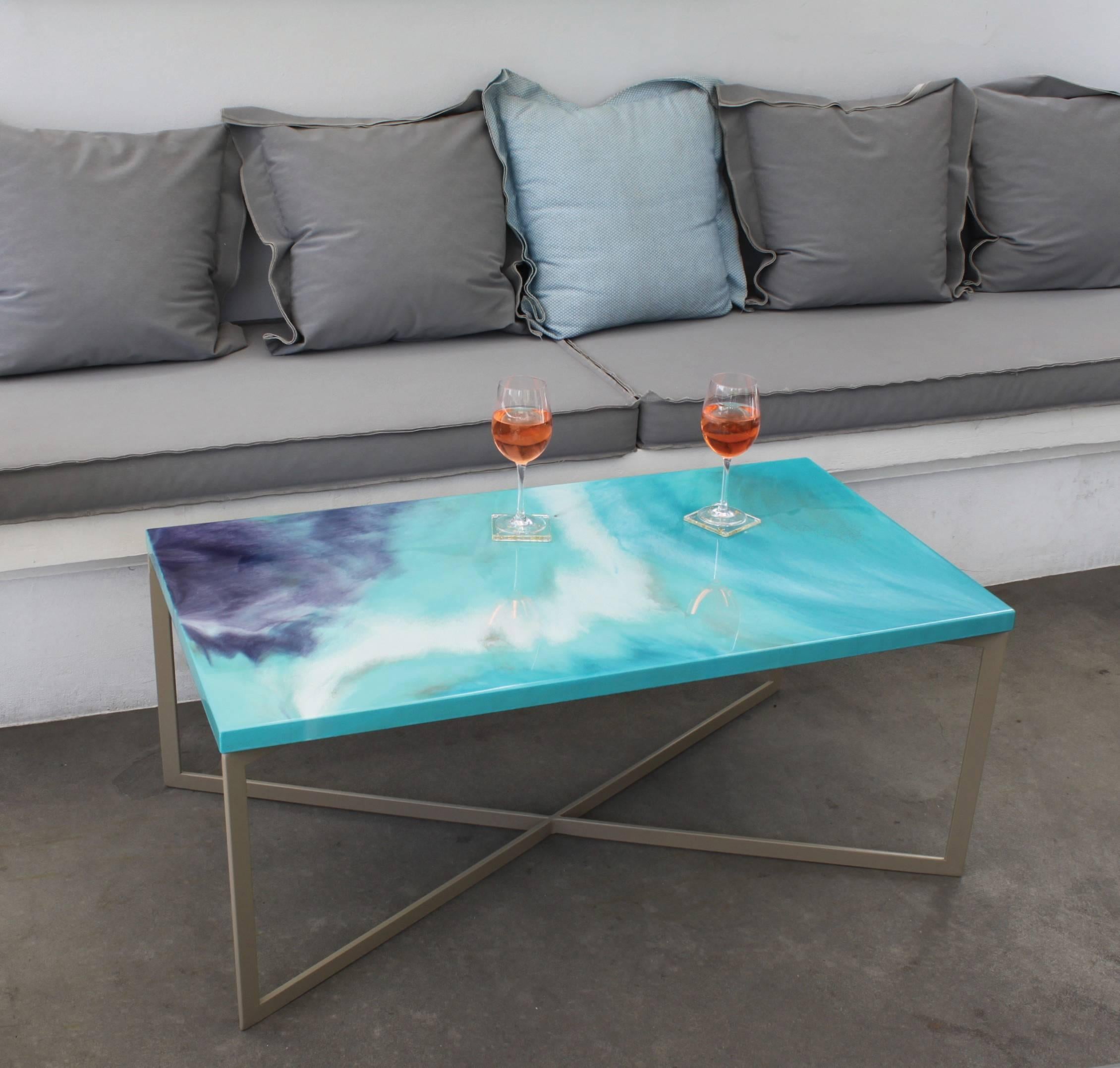 This elegant handmade coffee table is part of the Viscosity Art & Resin Gallery collection. The tabletop is made of handcrafted layers of colored resin on plywood. The vivid color combination with the ethereal flows makes this coffee table a unique