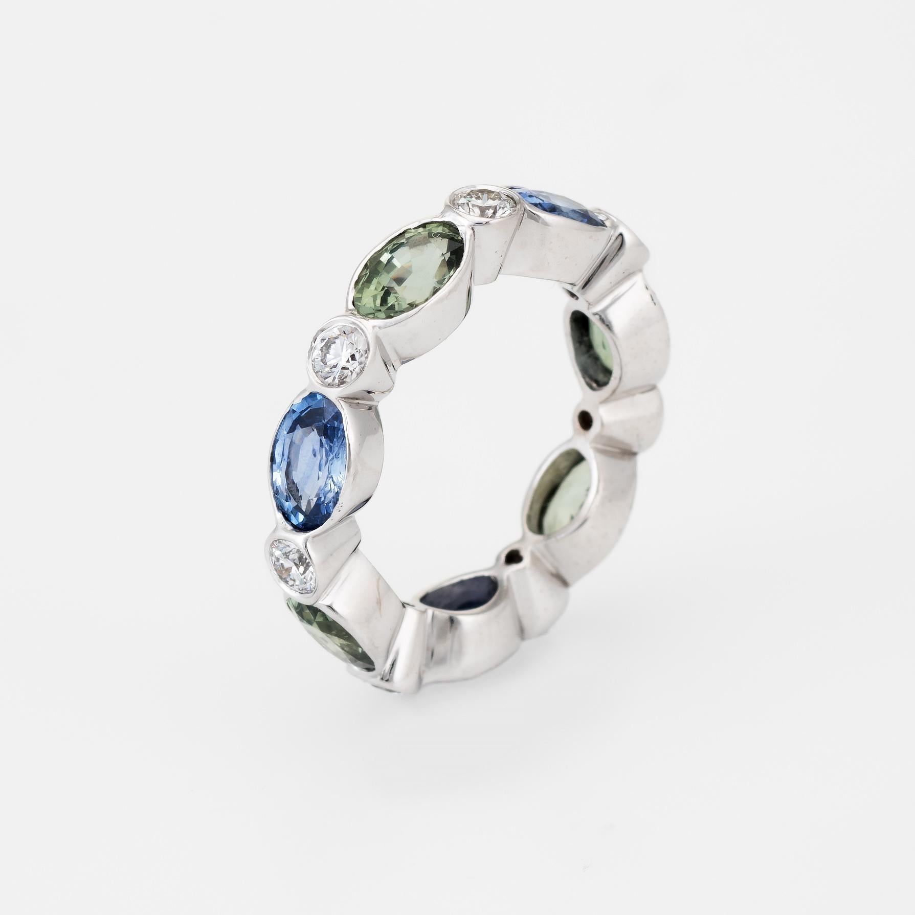 Finely detailed estate eternity ring, crafted in 18 karat white gold. 

Faceted oval cut green and blue sapphires each measure 6mm x 4mm (estimated at 0.50 carats each - 3.50 carats total estimated weight), accented with an estimated 0.42 carats of
