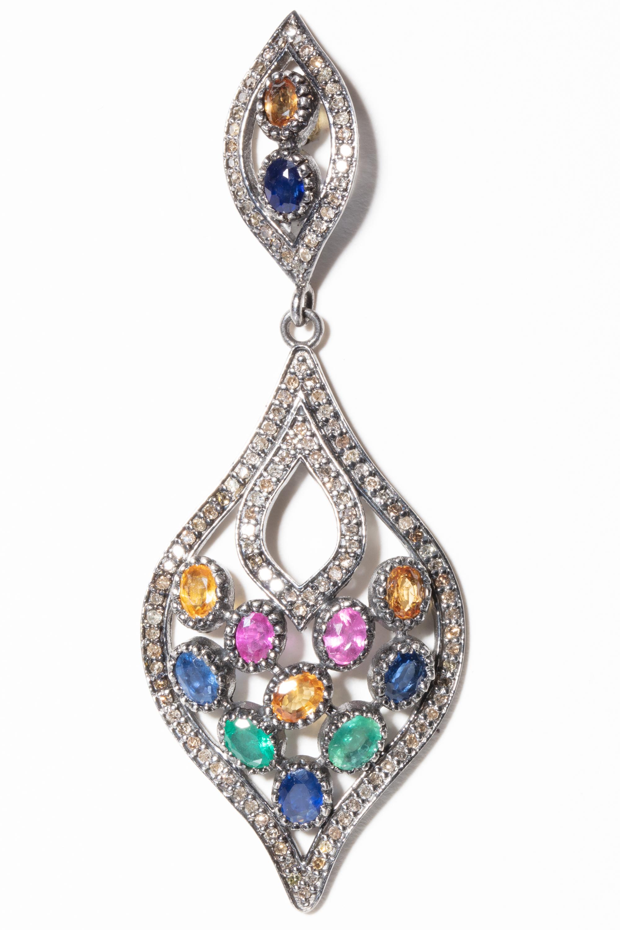 A mosaic of oval, faceted, colored (blue, pink, yellow and green) sapphires in a bezel setting bordered in pave`-set diamonds in sterling silver.  Carat weight of sapphires is 5.09 and diamonds are 1.80 carats.  For pierced ears.