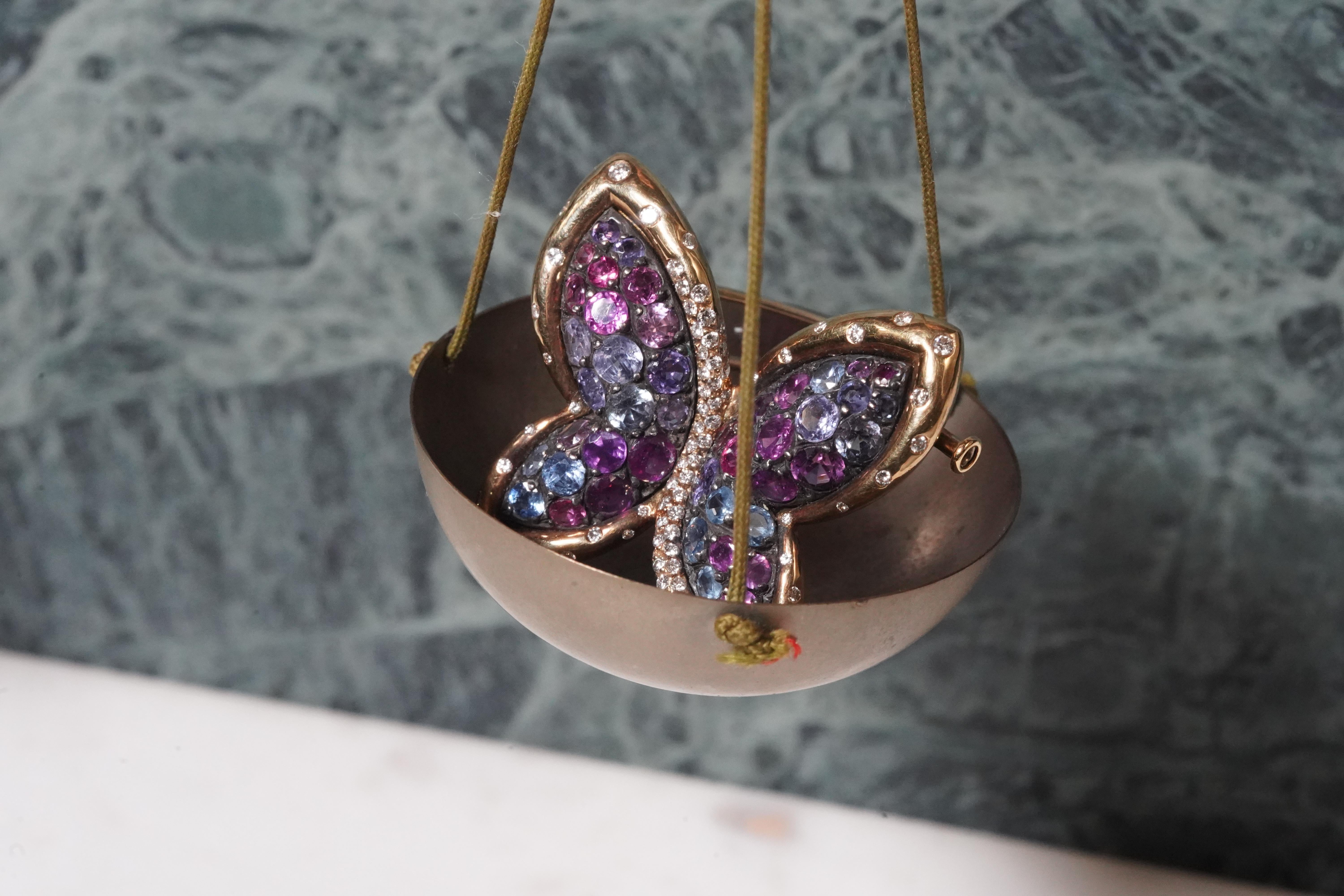 A beautiful gold and silver Butterfly brooch. This stunning piece features 7.72 carats of blue and pink sapphires, 0.78carat of white diamonds.The Butterfly's wings appearance reminds a stained glass. The elegant two-tone mounting is crafted in 18k