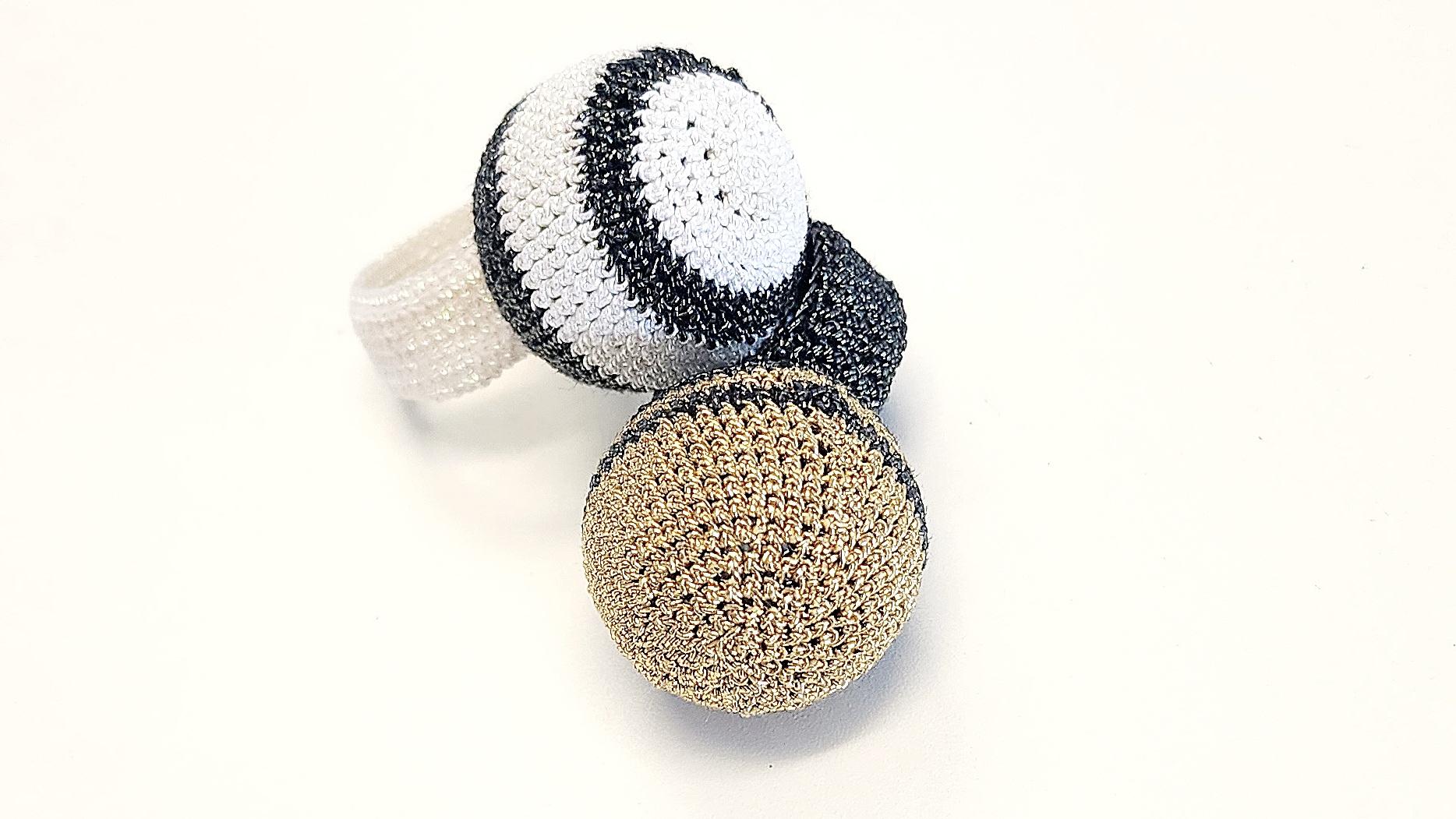 3 colorful crochet rings. The rings are crochet in different colors around a large round glass bead. The thread is a smooth passing thread. No metal content 
1 black and gold ring
2 black and white ring
3 gold, turquoise and white ring
Price is for