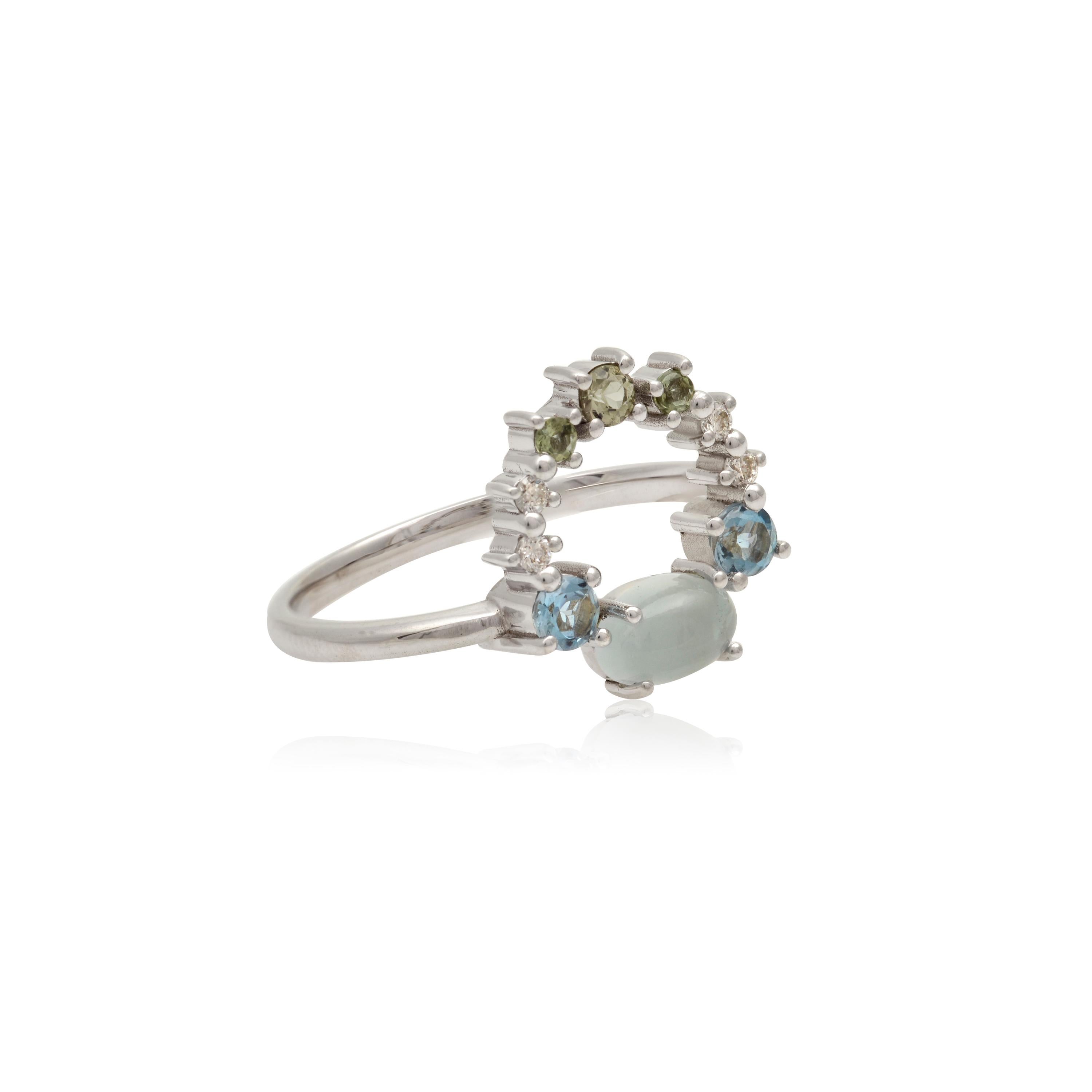 Designer: Alexia Gryllaki
Dimensions: L14x21mm
Ring Size UK P 1/2, US 8
Weight: approximately 3.1g 
Barcode: OFS008

Multi-stone ring in 18 karat white gold with an oval cabochon aquamarine approx. 0.60cts, round faceted aquamarines approx. 0.18cts,
