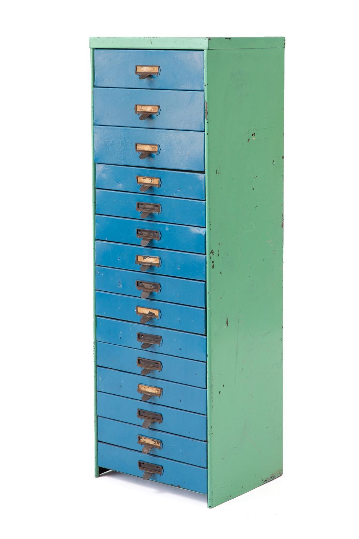 This eye-catching industrial metal slide cabinet from the 40s features beautiful patinated sea-foam green sides, turquoise drawer fronts and copper pulls.