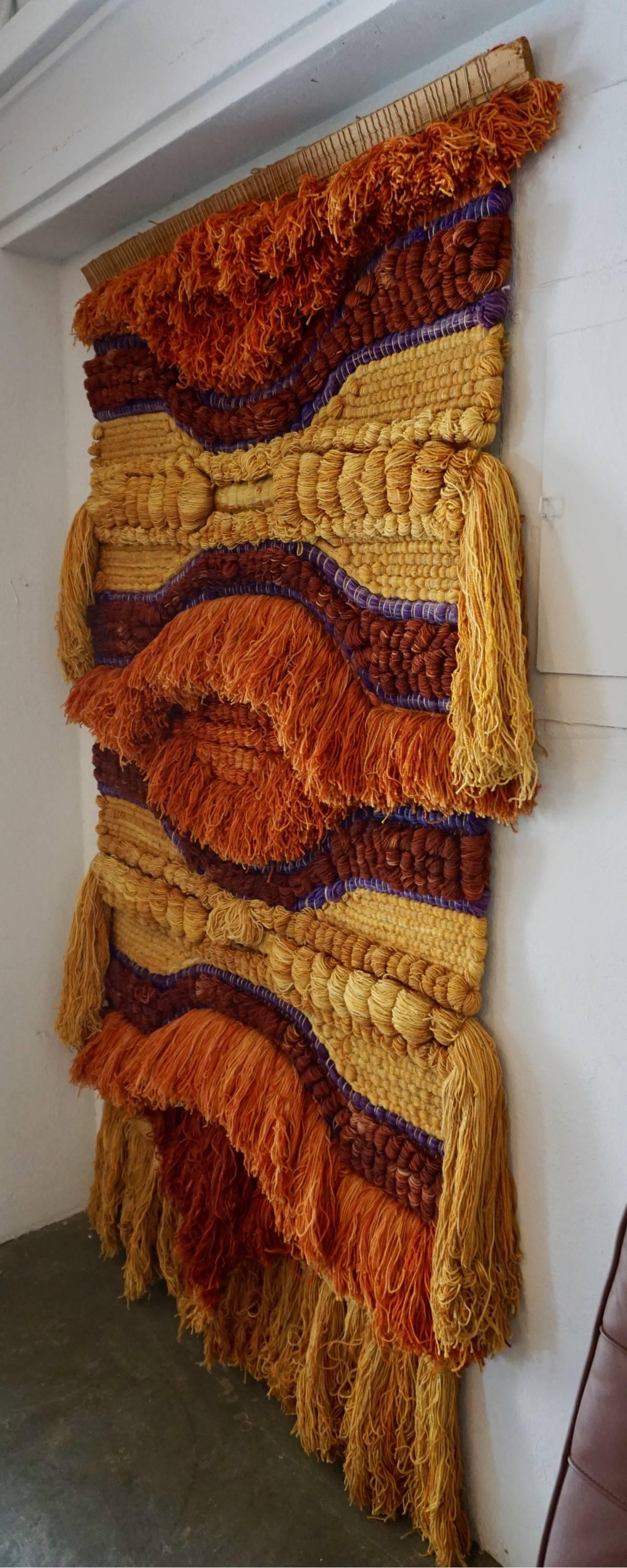 Woven, dyed and tufted yarns in bold colors of orange, burnt sienna and purple violet.
Excellent example of 1960s fiber art.