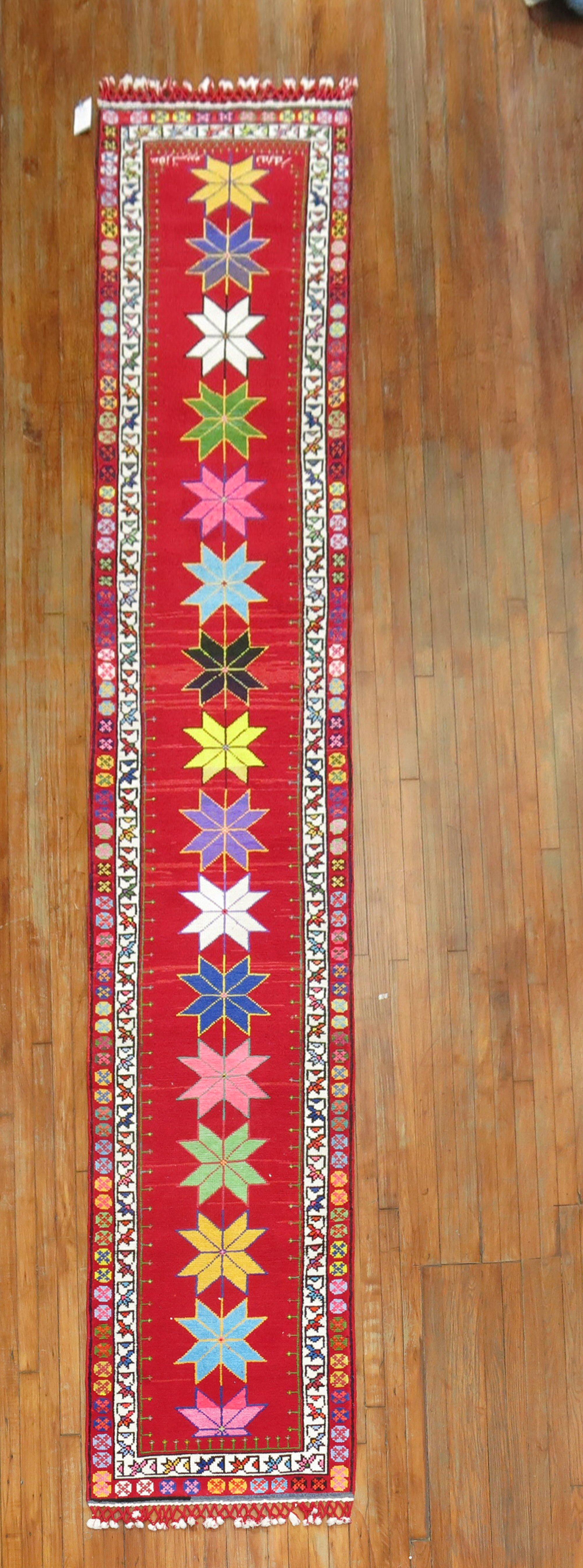 A funky colorful mid-20th century one of a kind Turkish runner woven in central Turkey. The weaver included longer fringes on each side giving it a unique characteristic.

Measures: 2'7'' x 14'3''.