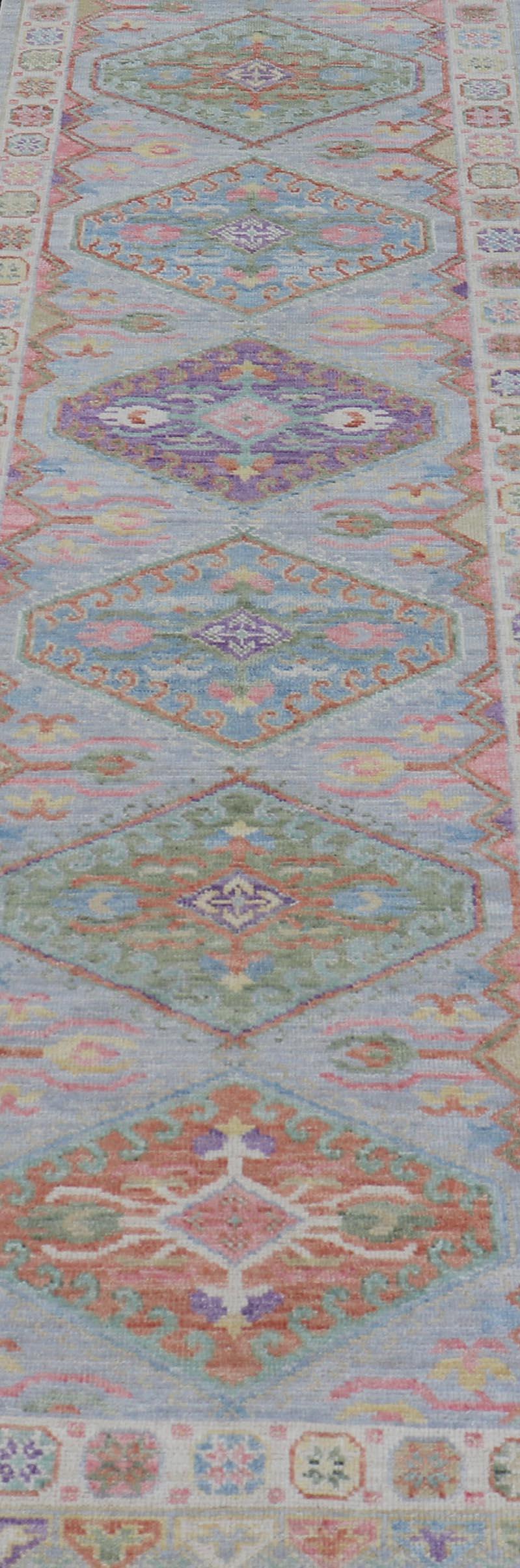This charismatic runner features medallions on a double-lined border, and larger diamond medallions in the field. Each medallion boasting the craftsmanship of every detail, and displaying colors such as grassy greens, oranges, blues, violet, red and