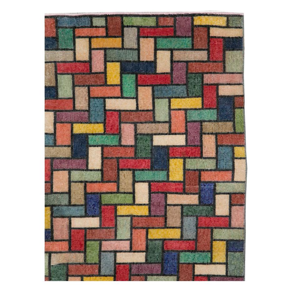 A vintage Turkish Anatolian accent rug handmade during the mid-20th century with a modern and colorful design in jewel tones.

Measures: 5' 0