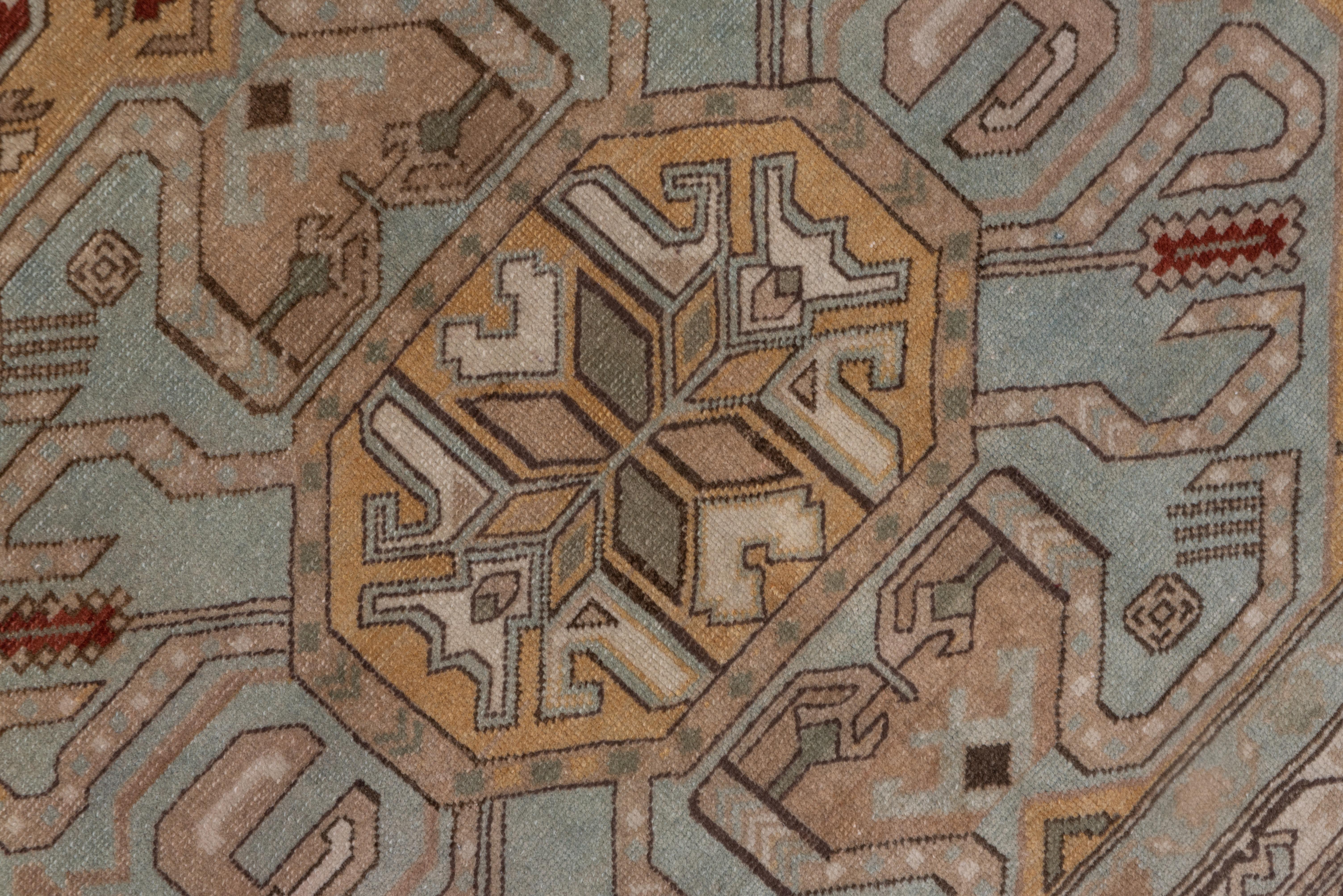The orange field features three octagons in powder blue and ecru, with wriggling dark brown cloud band shapes within, and a main border of rosettes within vinery octagons.