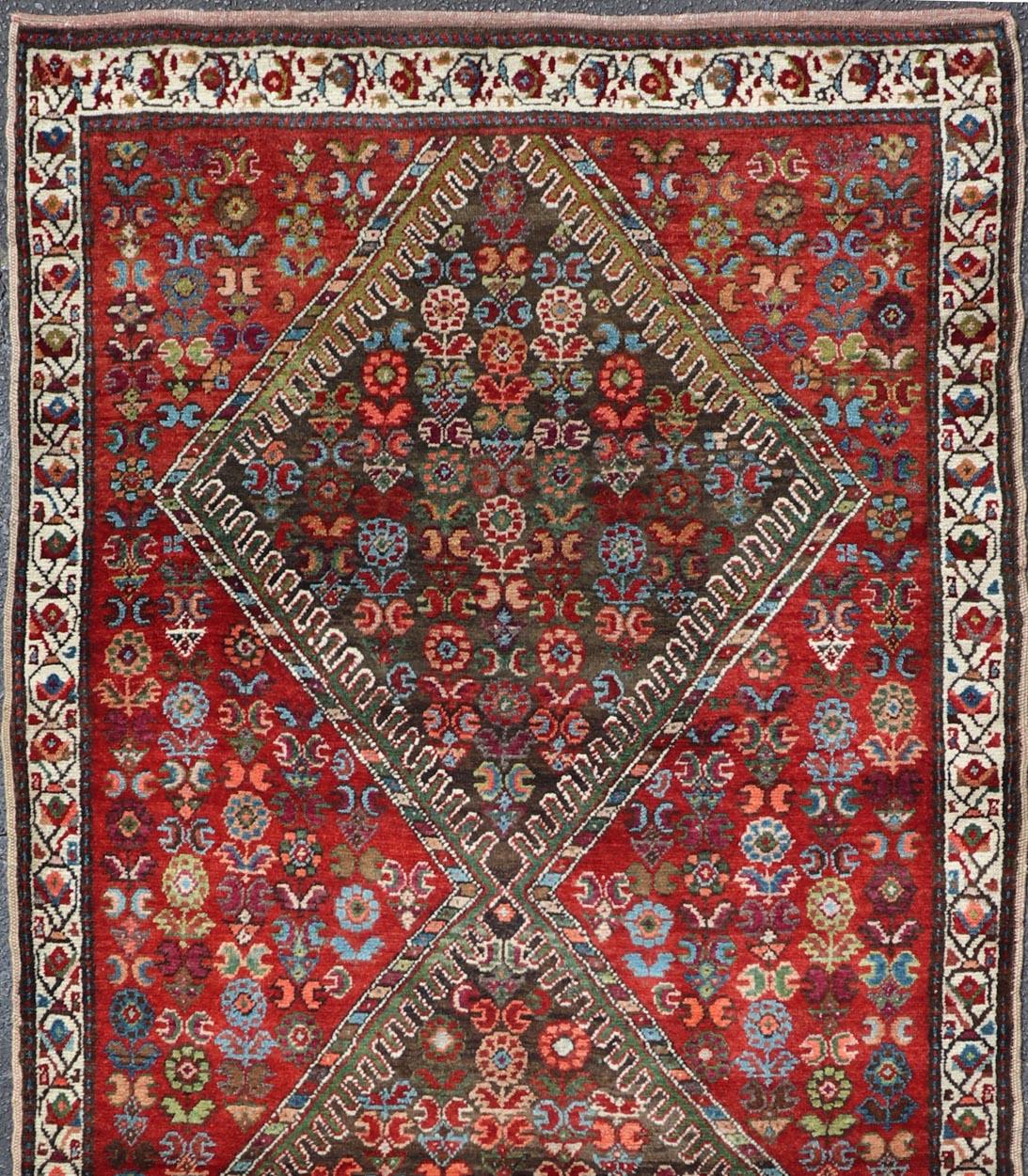 Colorful jewel-toned antique Caucasian Karabagh runner with tribal design, rug E-0704, country of origin / type: Caucasus / Karabagh, circa 1900.

The field design of this antique Karabagh runner (circa early 20th century) features medallions