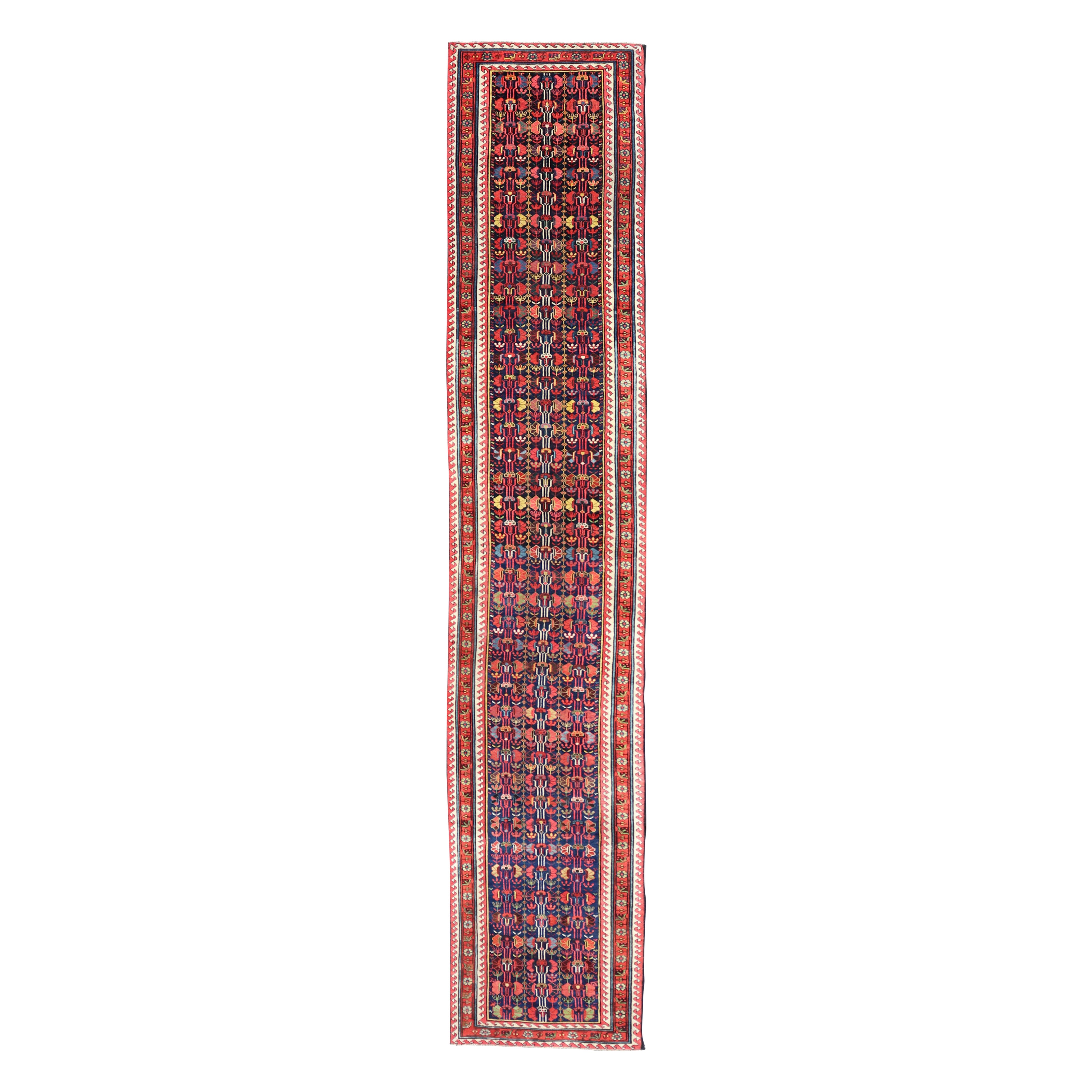Runner lungo Kazak antico e colorato con motivi multi geometrici su campo blu in vendita