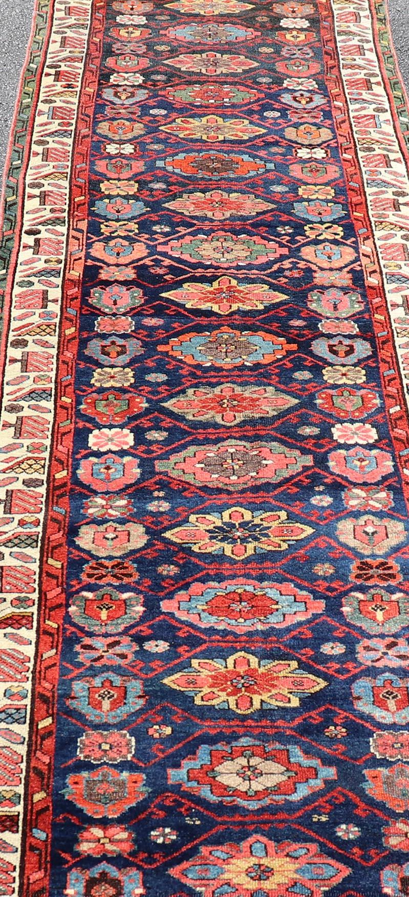 20th Century Colorful Antique N.W. Persian Runner with Sub-Geometric All-Over Floral Motifs  For Sale
