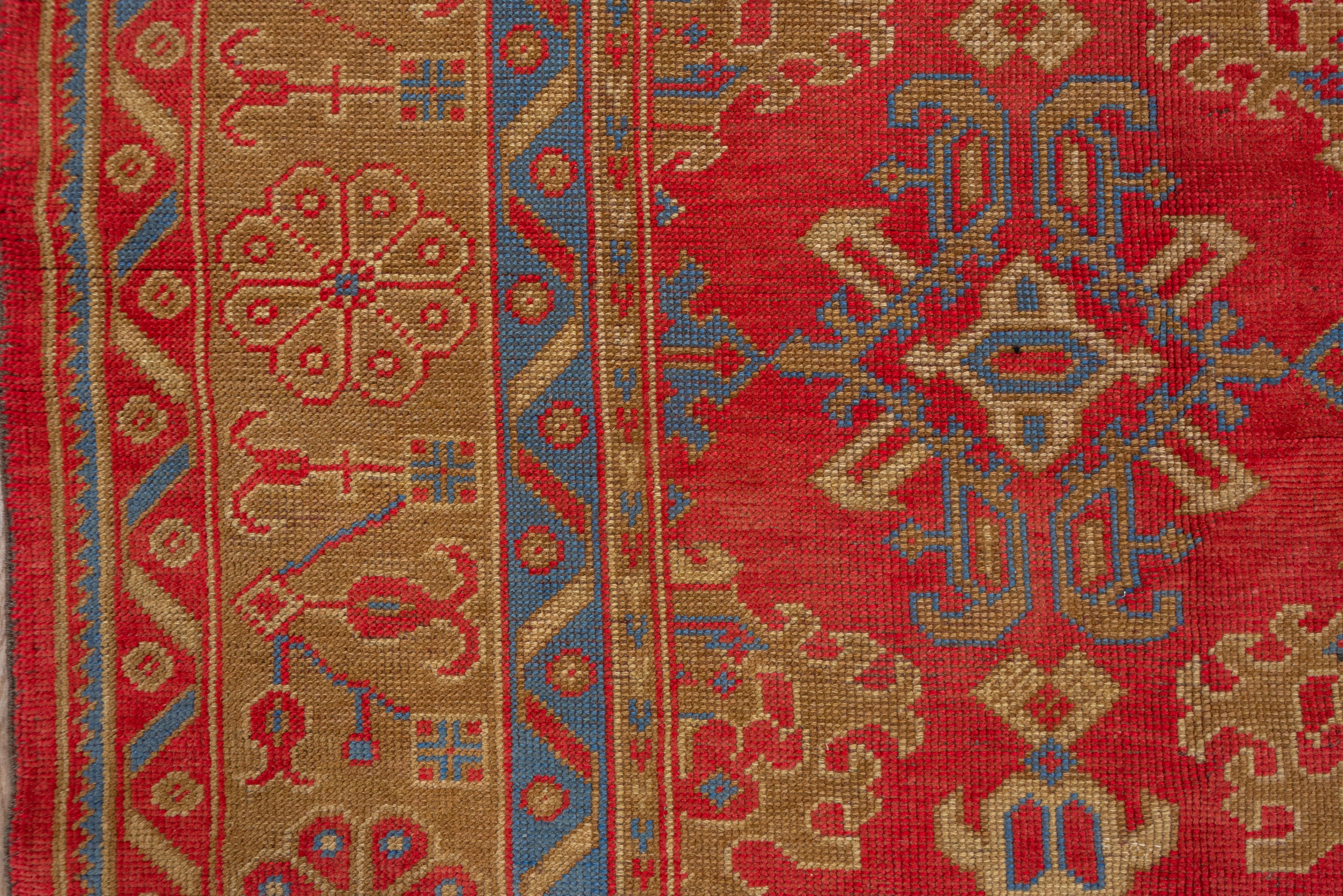 This superbly colored west Anatolian city carpet shows five full columns with elaborate ragged palmette and yaprak (leaf) designs on a brilliant madder red field and accented in a crisp cerulean blue. and beautiful teal. Green, blue & red borders