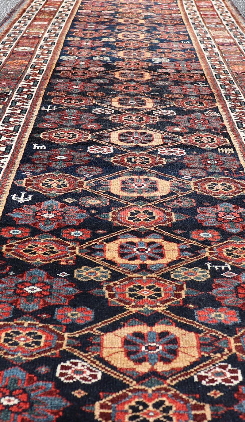 Tribal Colorful Antique Persian Lori Runner with Repeating Floral Palmette Design For Sale