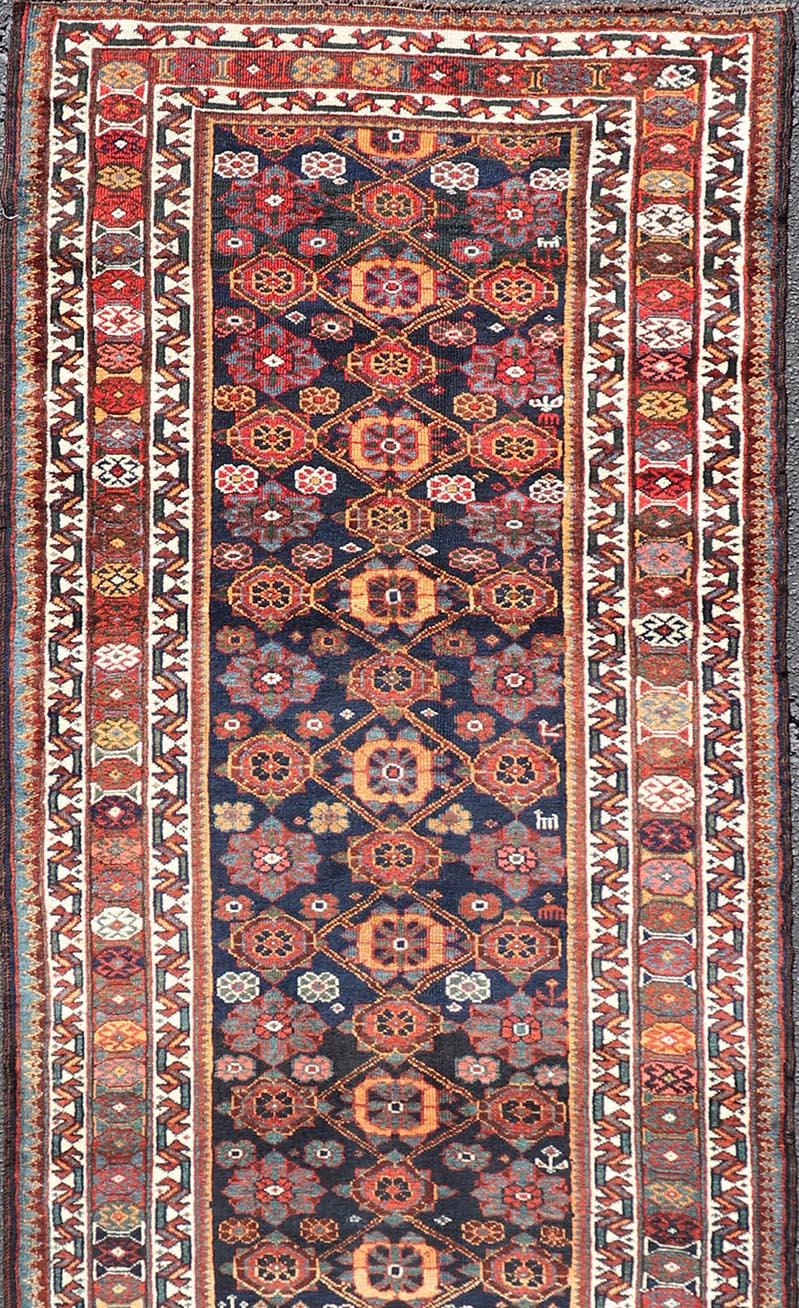 Wool Colorful Antique Persian Lori Runner with Repeating Floral Palmette Design For Sale