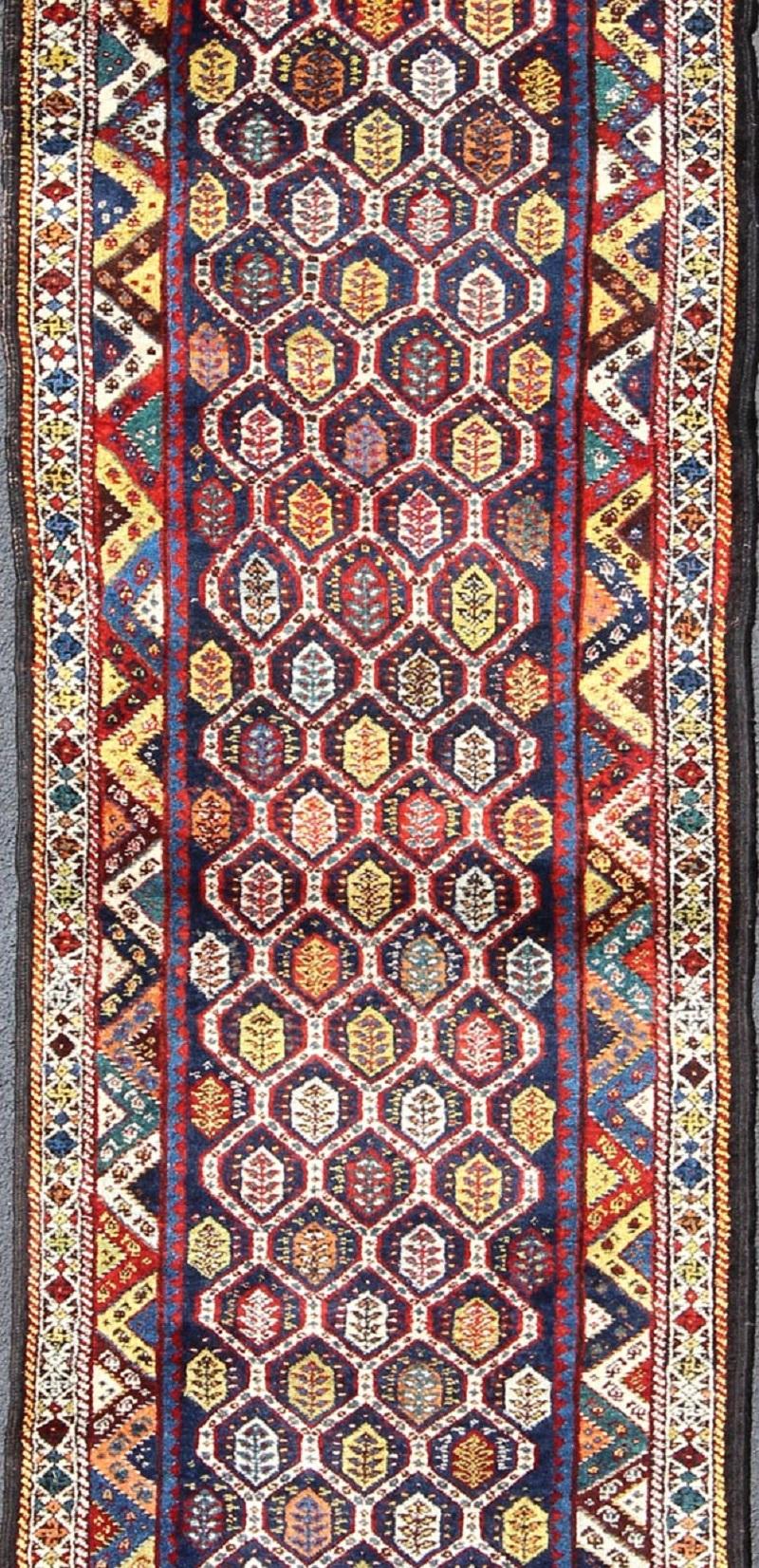 Tribal Colorful Antique Persian Lori Runner with Repeating Geometric Palmette Design For Sale