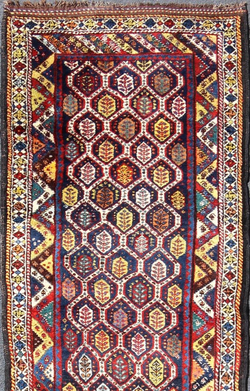 Hand-Knotted Colorful Antique Persian Lori Runner with Repeating Geometric Palmette Design For Sale