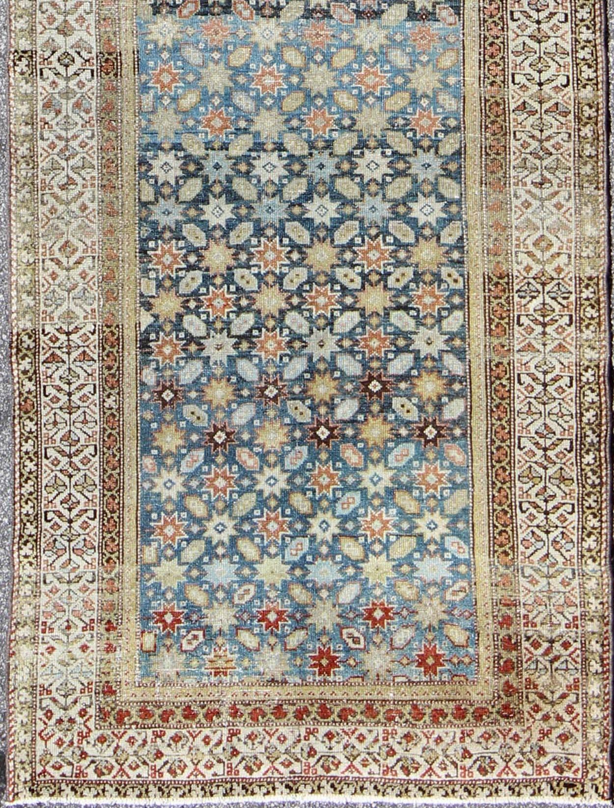 Colorful antique Persian Malayer runner with blue background, floral motifs, rug gld-7362, country of origin / type: Iran / Malayer, circa 1910

This Persian Malayer runner from early 20th century Iran features an all-over geometric floral pattern