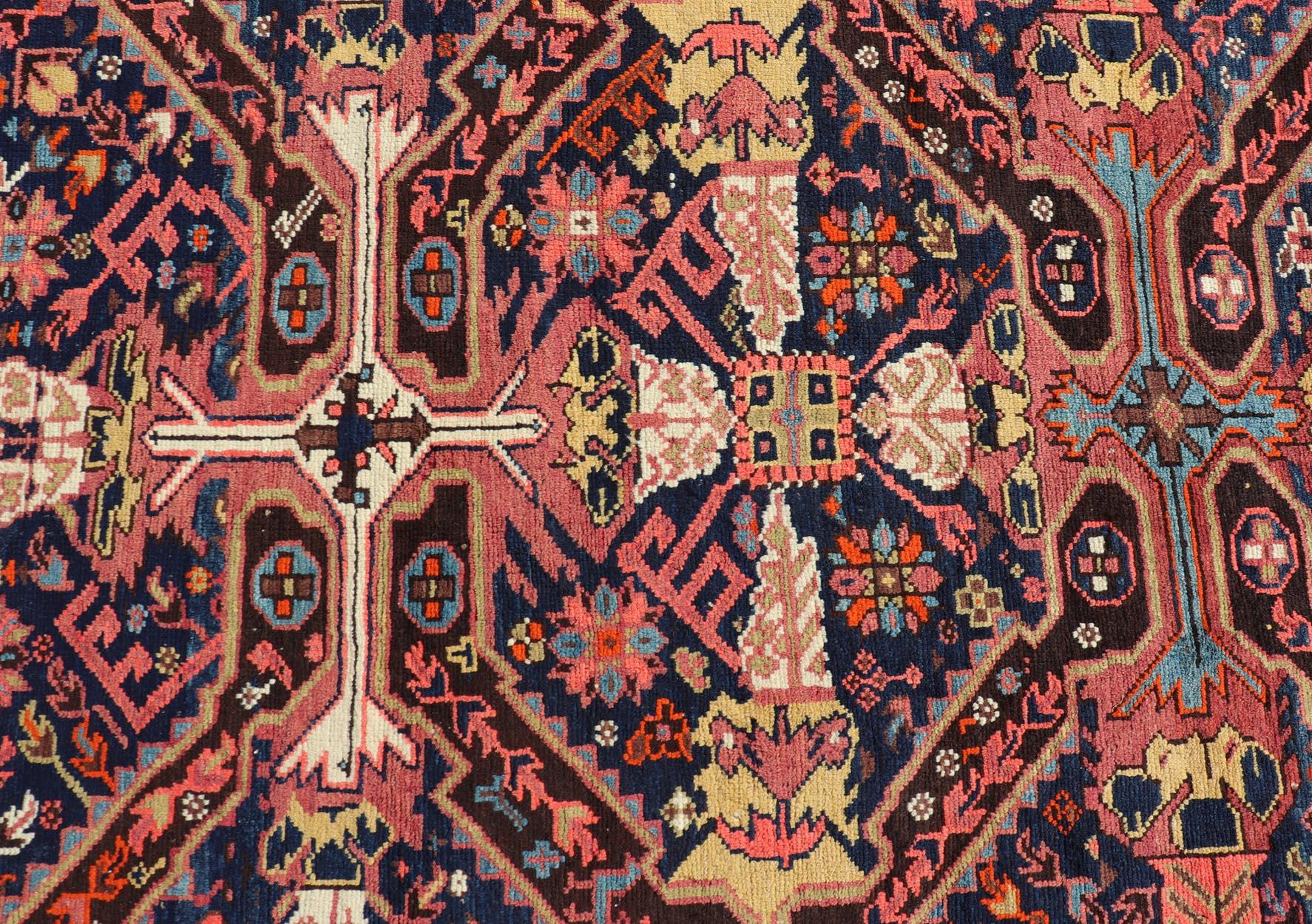 Measures: 5'10 x 12'10 

Seychour rugs are known for their heavily tribal designs. This fine piece in particular holds vibrant colors and bold contrasts. The middle field is a navy blue background with medallions decorated with ornate motifs in and