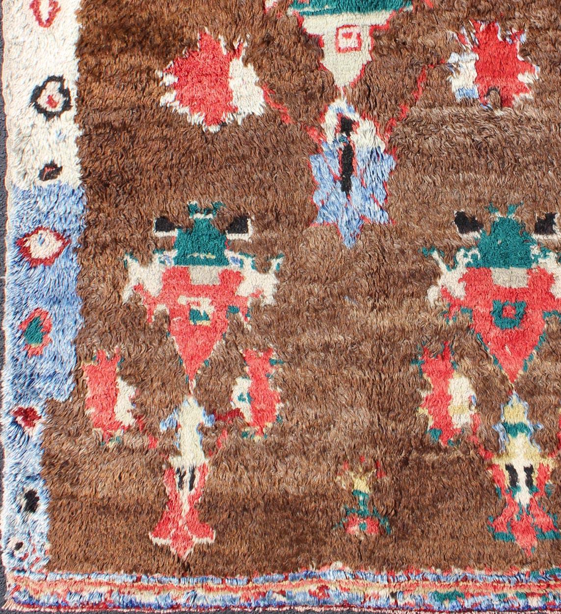 Colorful Antique Tulu Rug with Angora Wool Blend and Modern Tribal Design
This antique Tulu rug showcases a free-spirited design with stunning colors of blue, brown, green, red and cream. The high pile of this rare rug is angora wool, which adds