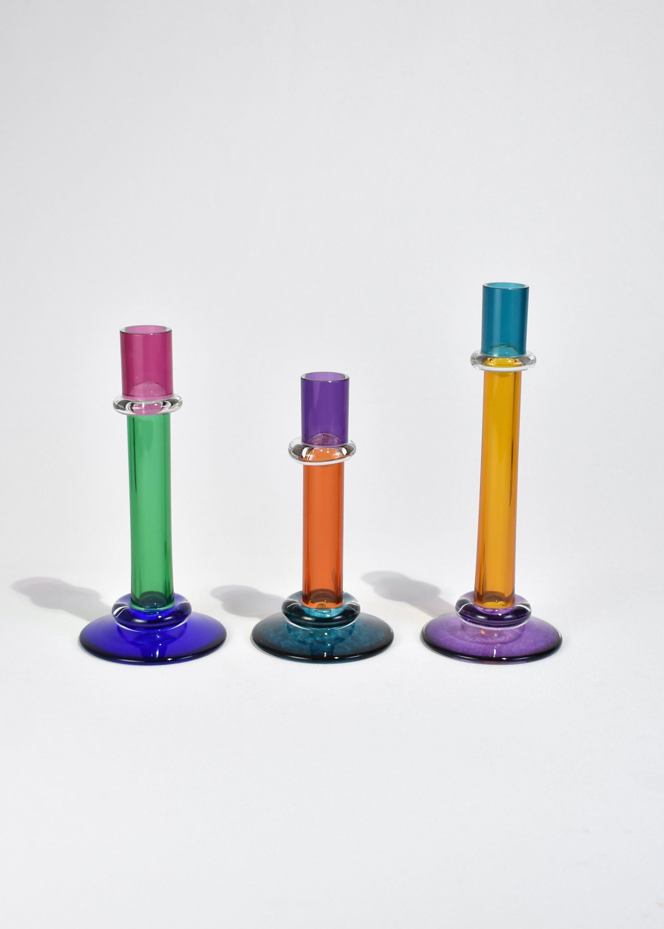 Colorful blown glass candleholder set of three with 1 inch (2.54 cm) diameter opening. Signed Chatham Glass Company, 1999.

Dimensions:
9.25 in (23.49 cm) tall, 3.5 in (8.89 cm) wide
8 in (20.32 cm) tall, 3.75 in (9.52 cm) wide
7 in (17.78 cm)