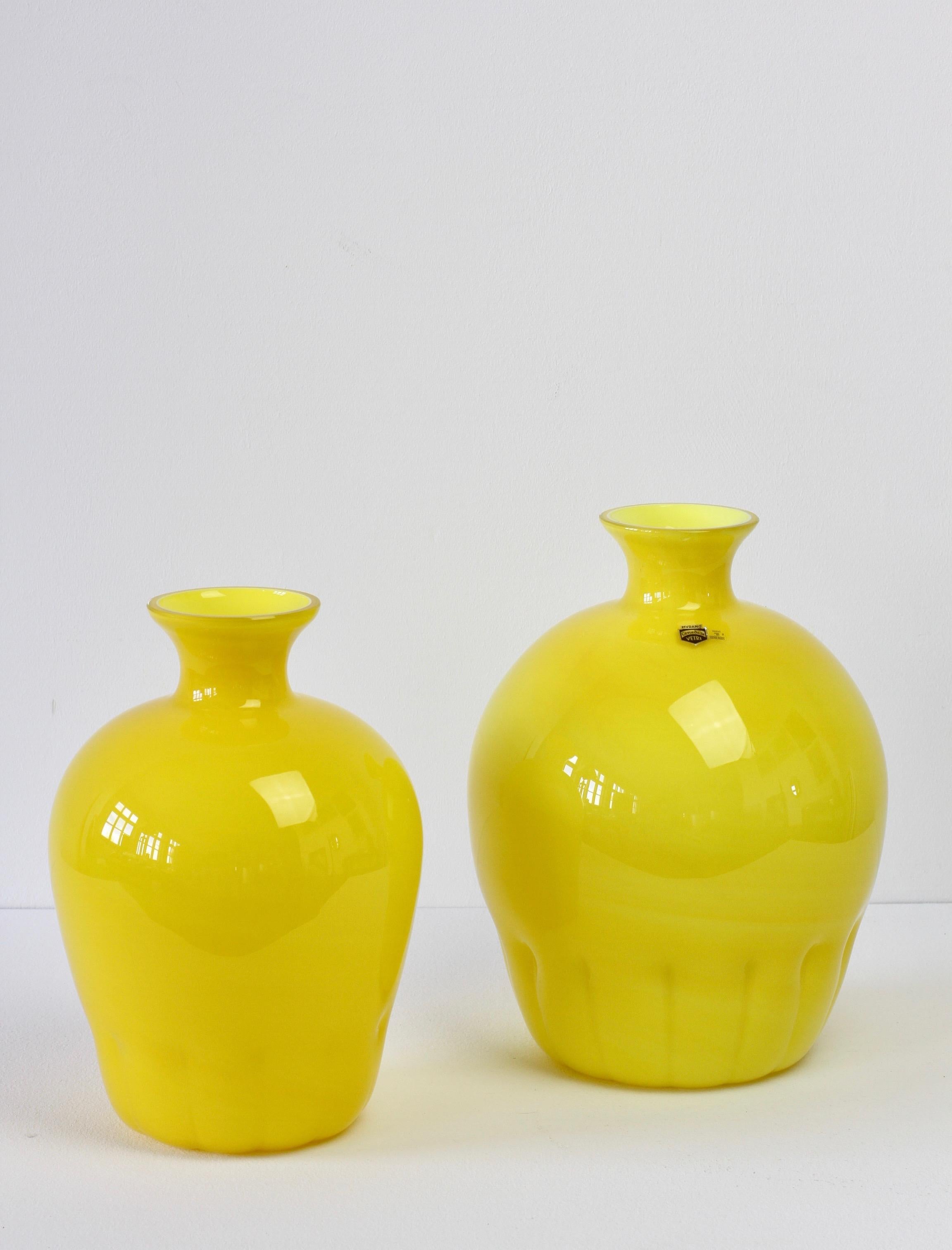 Colorful or colorful pair, group or ensemble of midcentury style bright yellow vases by Cenedese Vetri of Murano, Italy, circa 1990s. Particularly striking is the narrow necked round form with rippled bases, very similar to Napoleone Martinuzzi