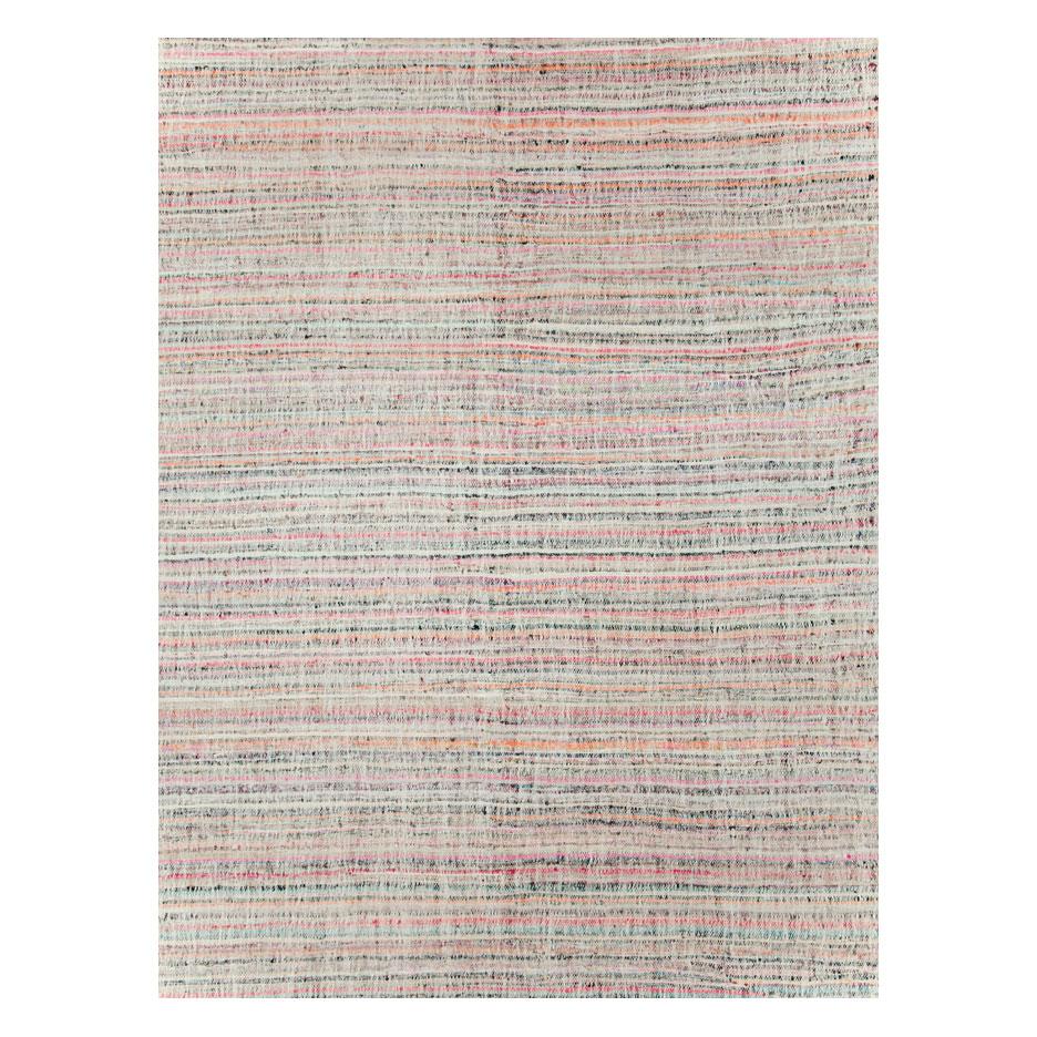 A modern Turkish flat-weave Kilim large room size carpet handmade during the 21st century with a horizontally striped pattern in soft, but colorful tones similar to the style of American rag rugs.

Measures: 13' 1