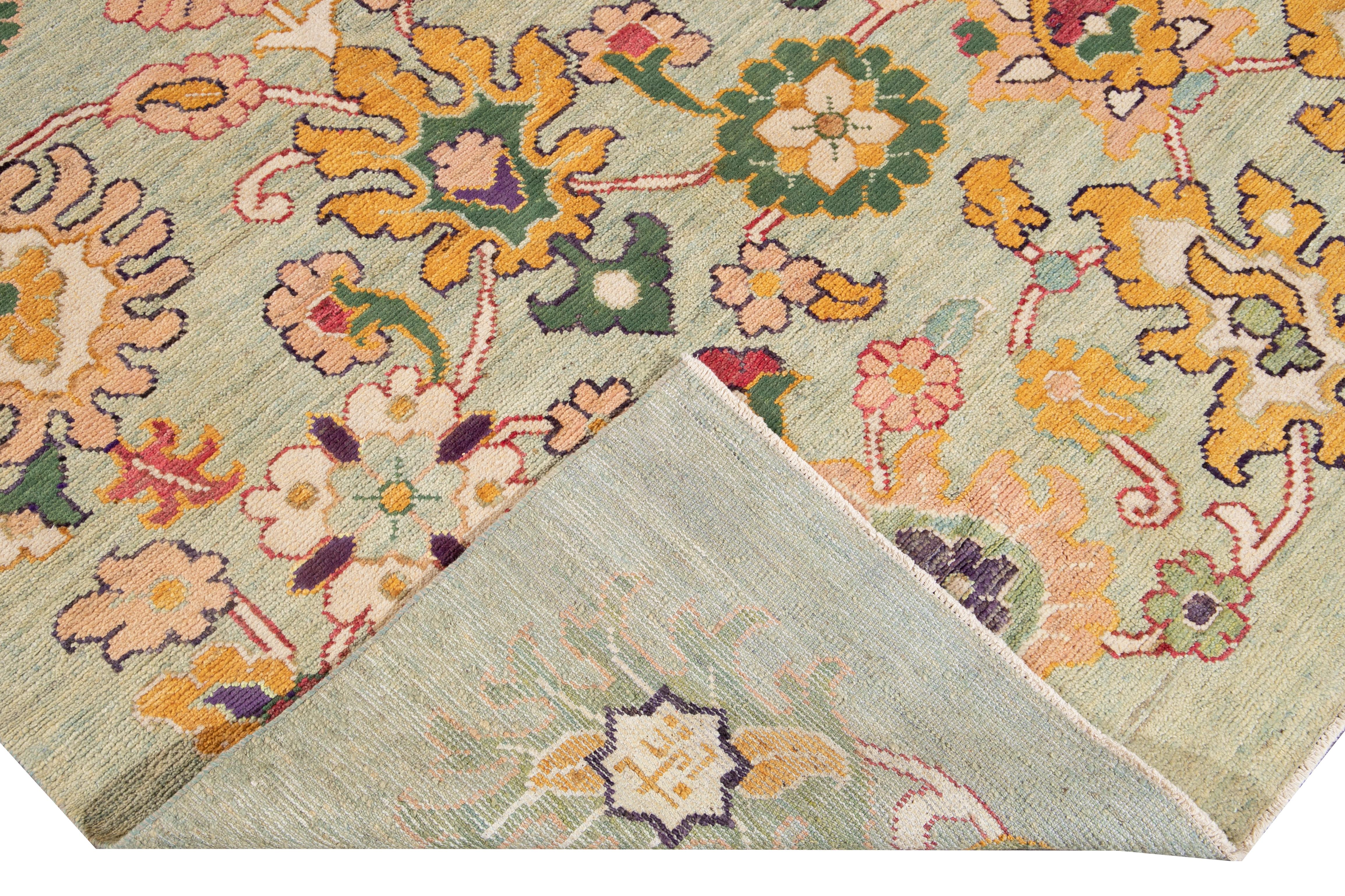 Beautiful Modern Oushak hand knotted wool rug with a green field. This Oushak rug has multi-color accents all-over a gorgeous botanical floral design. 

This rug measures: 8'8