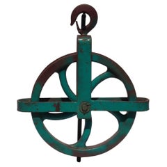 Vintage Colorful Dark Maroon and Teal Large Industrial Cast Iron Pulley on a Metal Base
