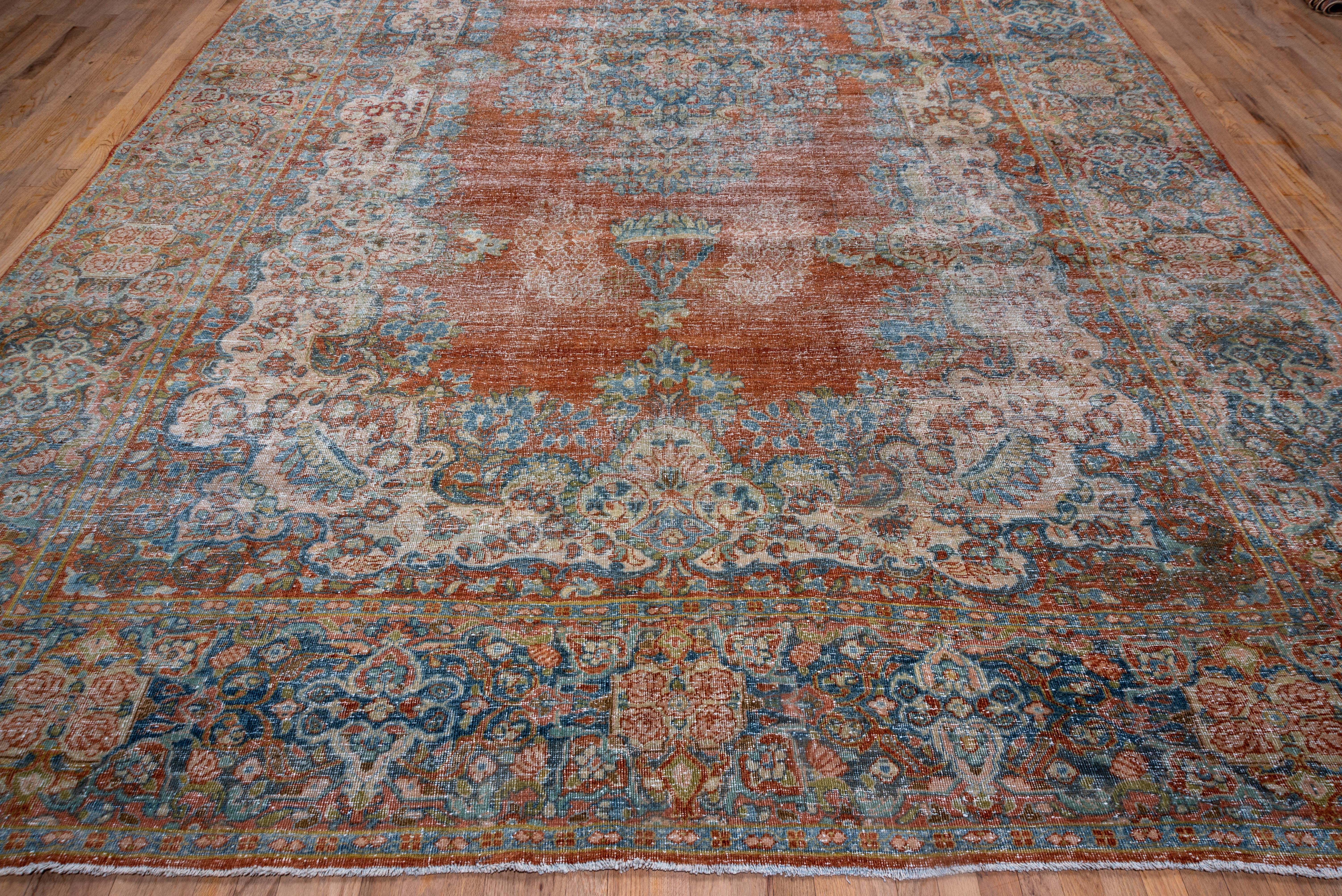 This rust field west Persian village carpet shows an unusual sand wreath pattern around the slate medallion. Boteh-shaped flower clusres decorate the field as well. The slate border shows sandy quatrefoils enclosing roses.
   