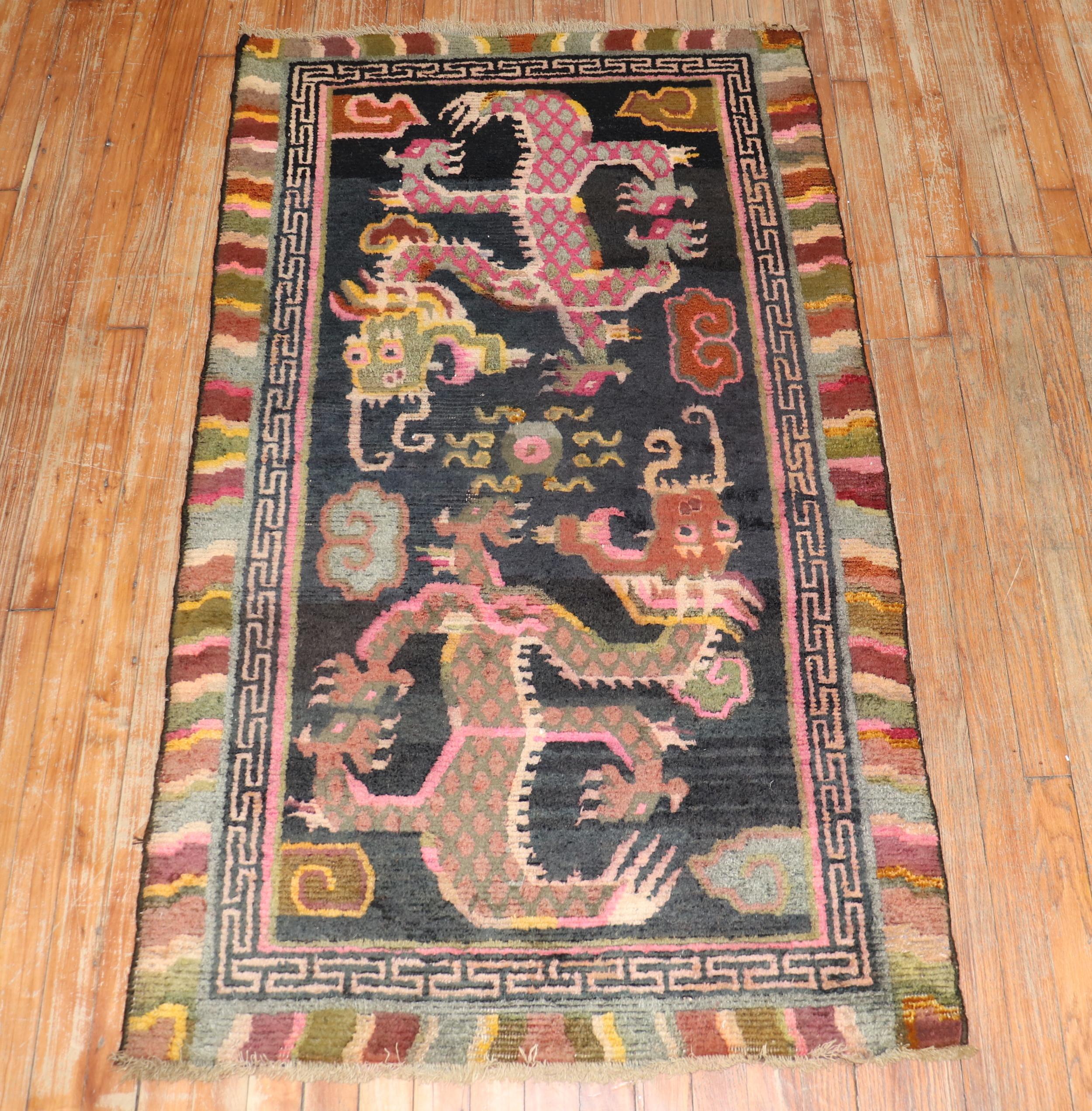 1st Quarter of the 20th-century Tibetan rug with a large-scale dragon motif.
The wool is soft, Texture and patina are fabulous. Can also make for a suitable wall hanging.

Measures: 2'9