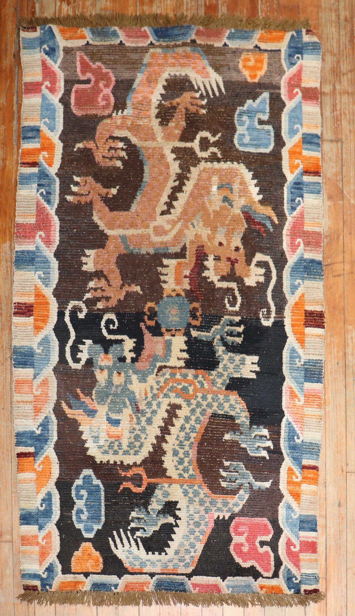 1st Quarter of the 20th century Tibetan rug with a large-scale dragon motif.
The wool is soft, Texture and patina are fabulous. Can also make for a suitable wall hanging.

Measures: 2'9