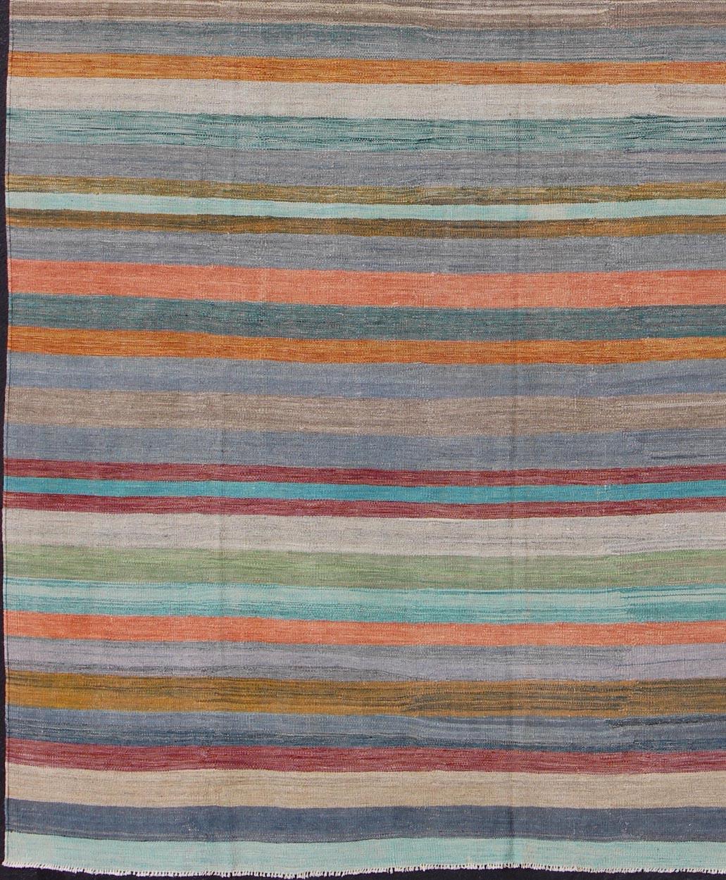 Casual flat-weave Kilim rug with rainbow colors in Classic stripe design, rug afg-14936, country of origin / type: Afghanistan / Kilim
Colorful flat-weave modern Kilim rug with Classic stripes for Modern Interiors.
This fun and vibrant kilim rug