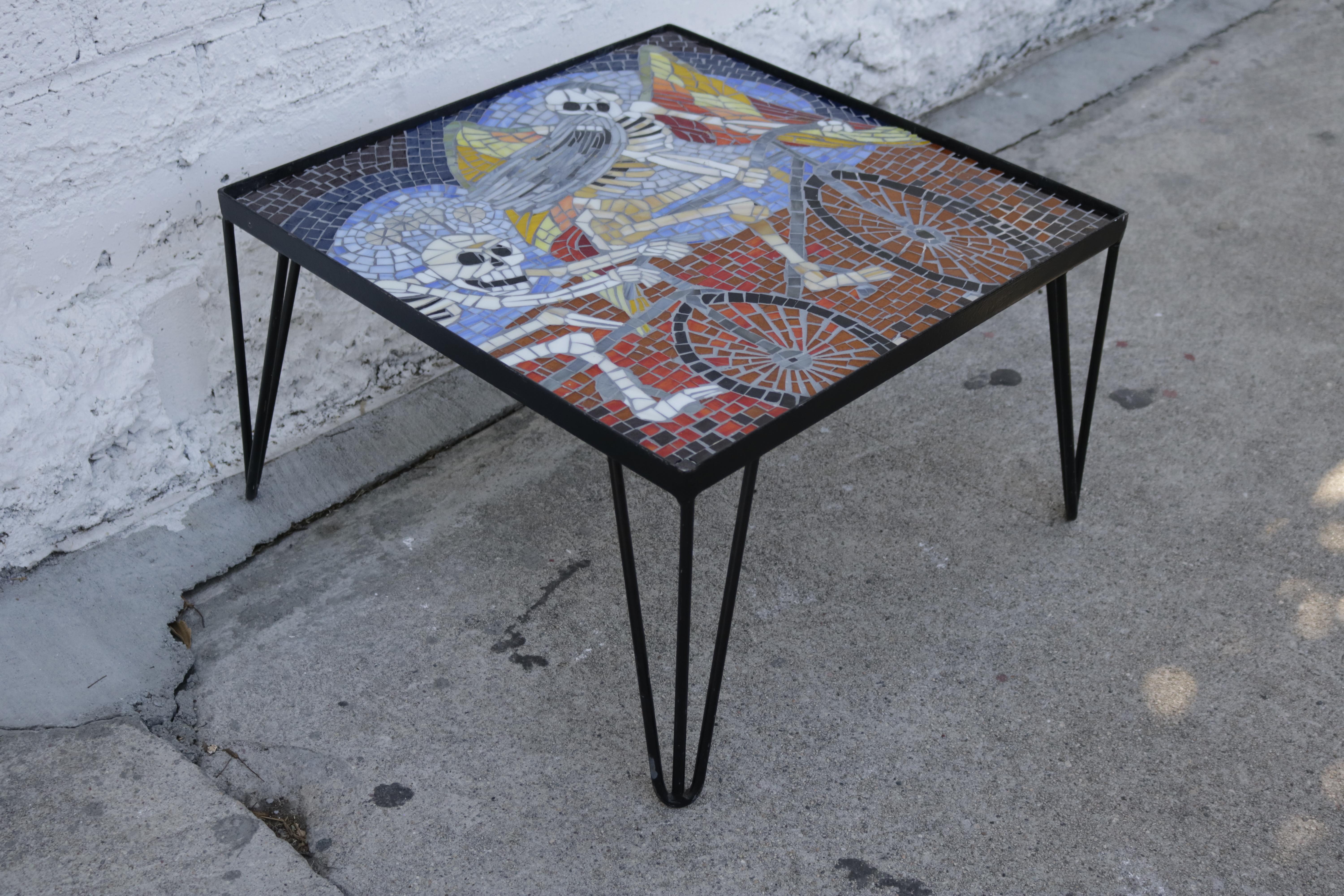 The top of this coffee or side table is made of stained glass tiles on a metal frame with 4 hairpin legs. It is signed Nedresky.
 