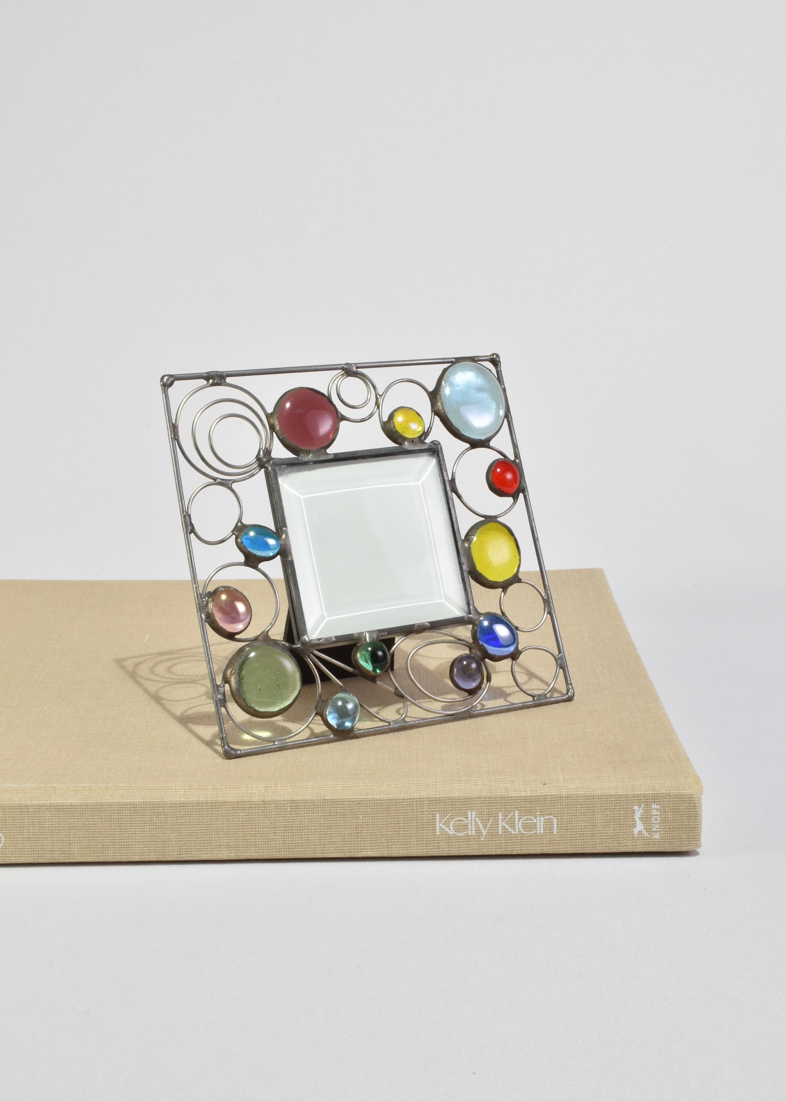 One-of-a-kind handmade metal picture frame with colorful glass detail.