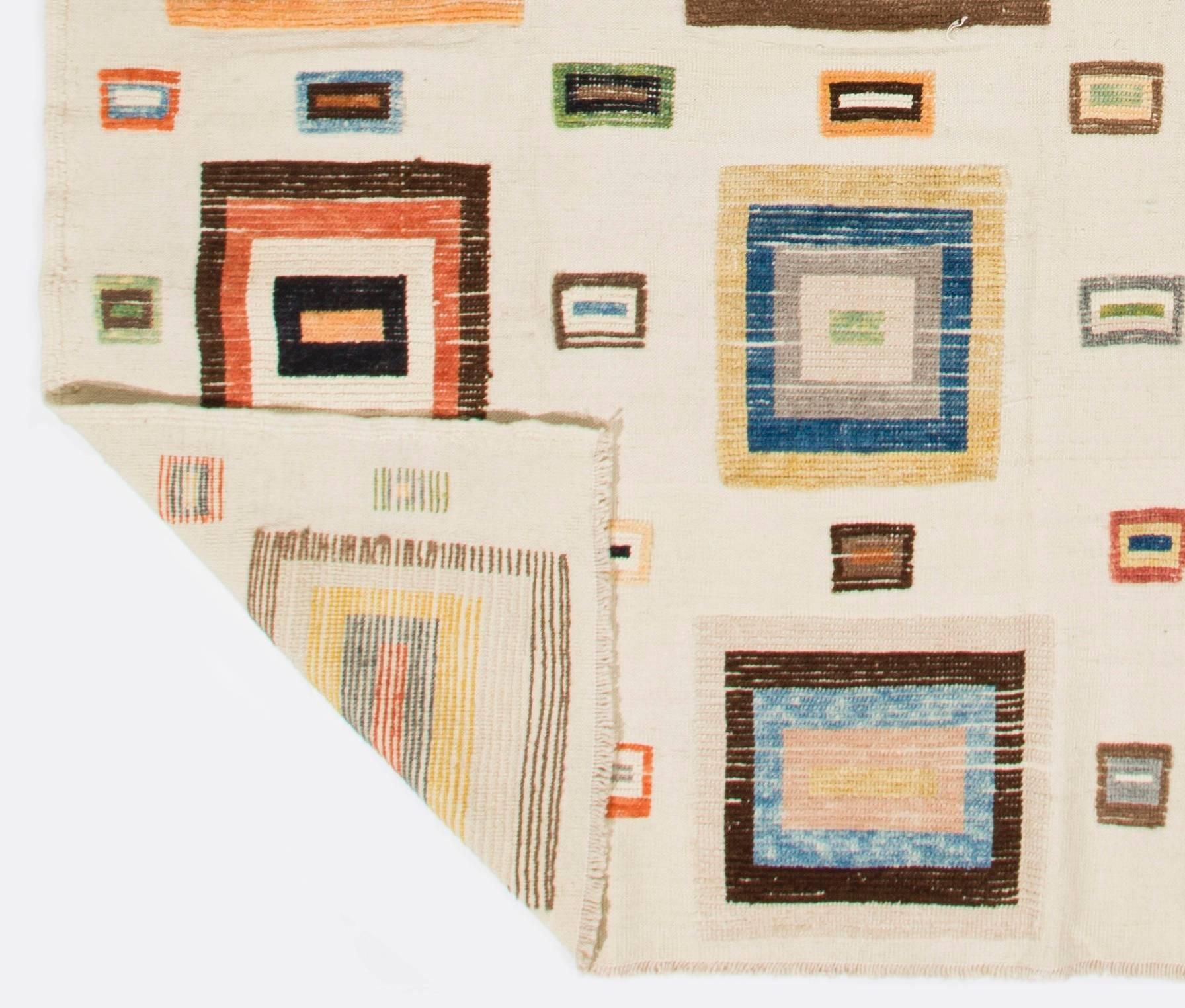 A Turkish tulu rug with colorful geometric boxes on a cream background. 100% wool. The cream ground is hand-woven (kilim) and the patterns are hand-knotted. Even low pile throughout. 

It is available in 8.7 x 11.7 Ft (263 x 356 cm) and 5 x 8 ft