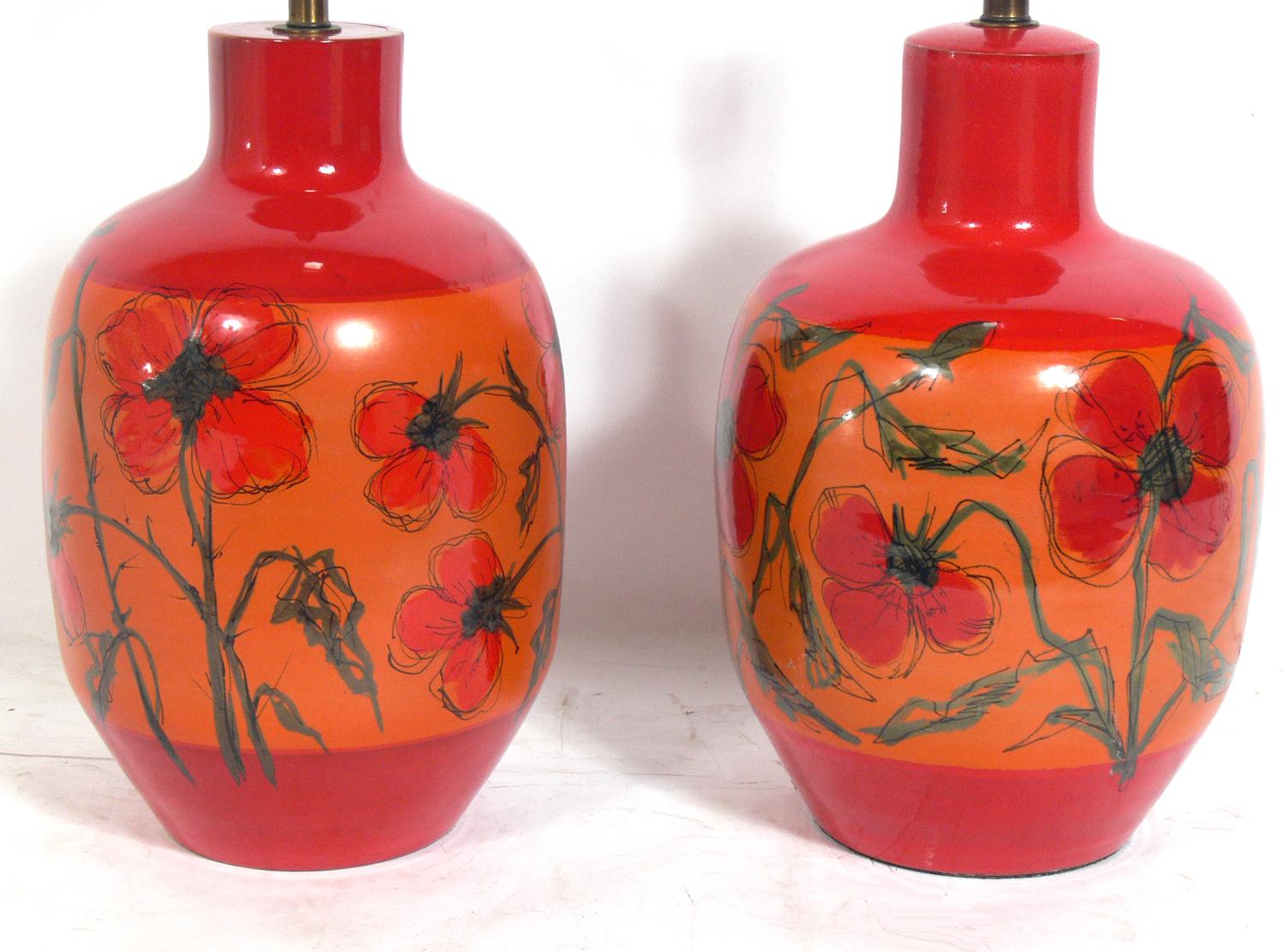 Colorful Italian ceramic lamps, made in Italy and imported to the US for Raymor, circa 1960s. Vibrant orange and red colors with wonderful hand painted details. They are a near pair, and have subtle differences as they are handmade. The differences
