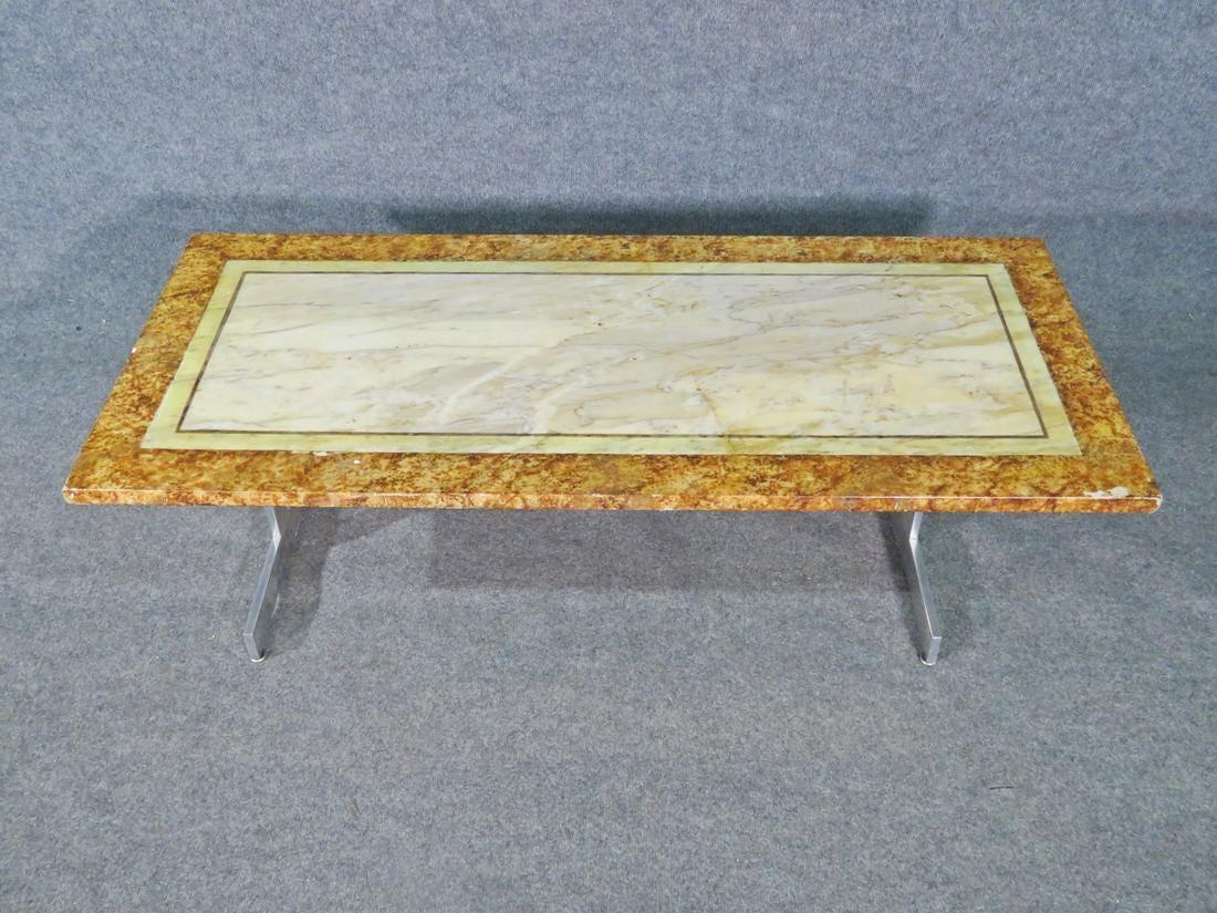 Three different shades of marble paired with a sleek chrome base make this coffee table unique and eye-catching. Please confirm item location with seller (NY/NJ).