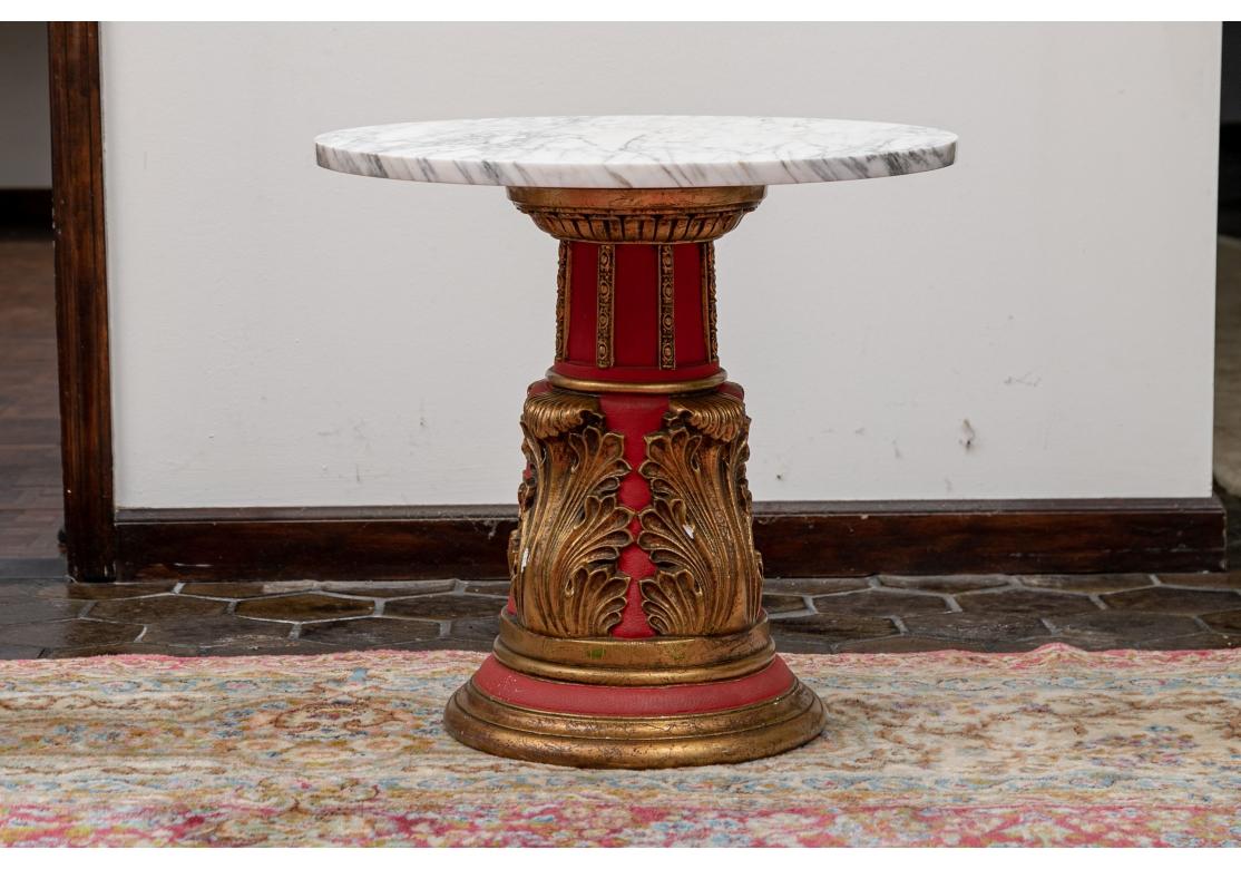 A vintage column from table suitable as a small tea table or end table. With gilt laurel leaf motif against a striking deep rouge base and having a gray flecked marble top, the table is as artistically styled as it is useful. Very good condition