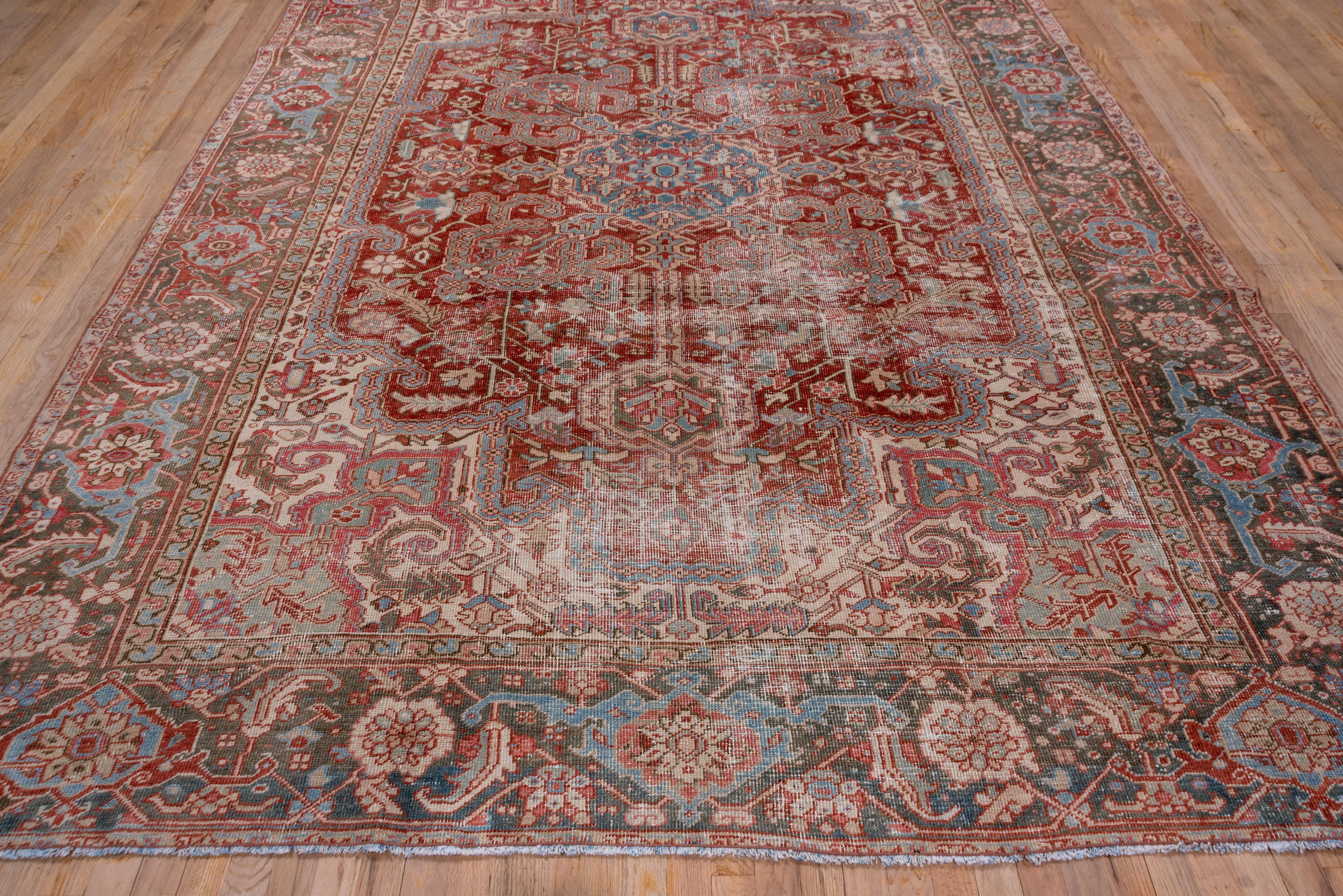 Heriz Serapi Colorful Lightly Distressed Antique Persian Heriz Rug, Red Field, Green Borders For Sale