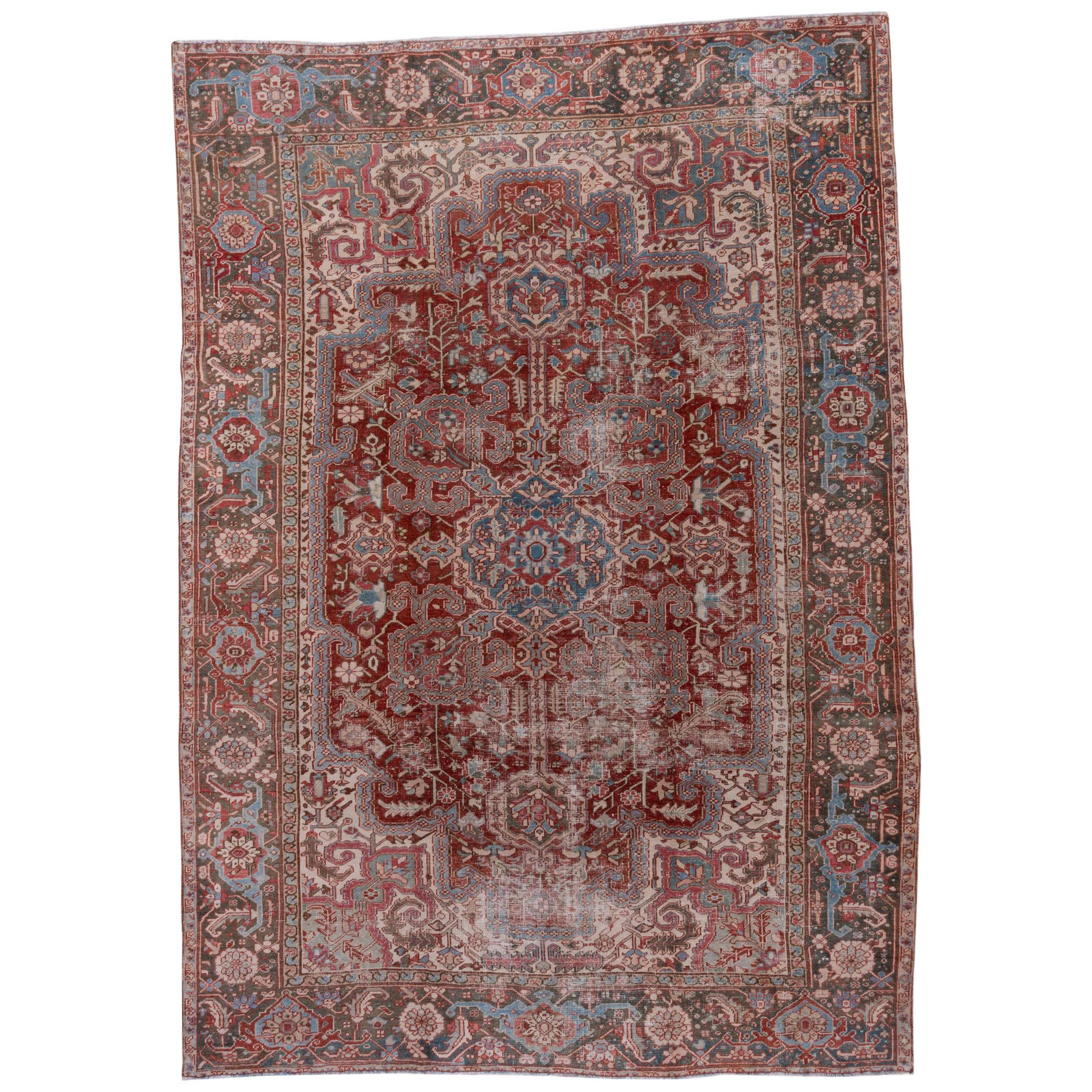 Colorful Lightly Distressed Antique Persian Heriz Rug, Red Field, Green Borders For Sale